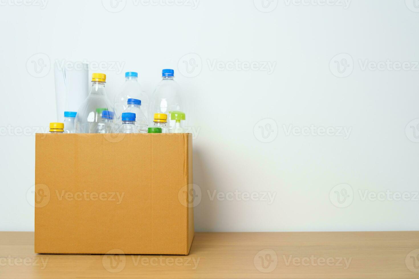 Plastic bottle in paper box at home or office. Recycle garbage Sorting. Plastic Free, Ecology, Environmental, pollution, Dispose recycling, waste management and trash Separation concept photo