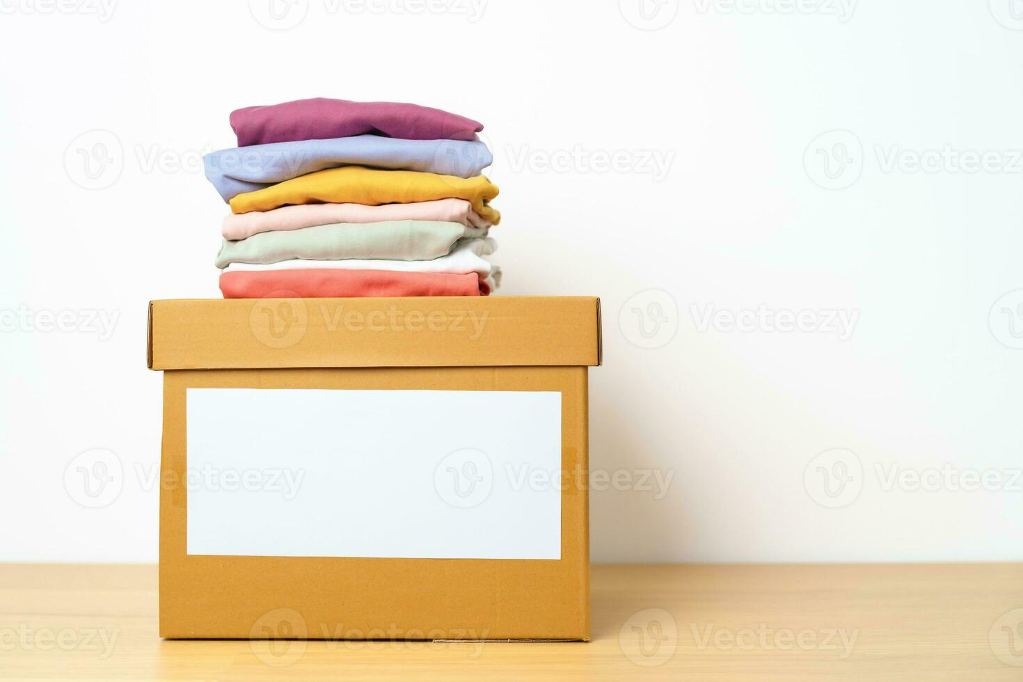 Donation, Charity, Volunteer, Giving, Delivery and Home Moving Concept. Clothes with cardboard box at home or offices for support and help poor, refugee and homeless people. Copy space for text photo