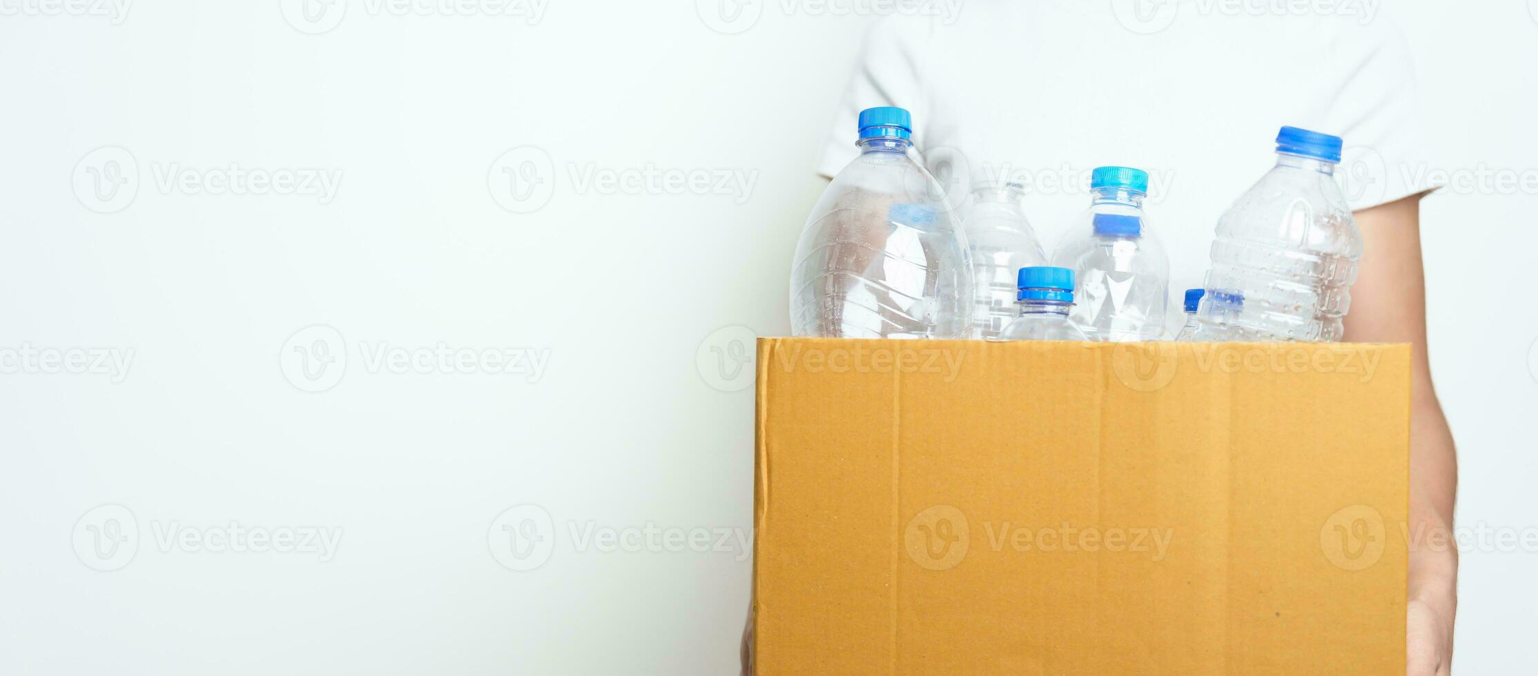 Volunteer keep plastic bottle into paper box at home or office. Hand Sorting Recycle garbage. Ecology, Environmental, pollution, Dispose recycling, waste management and trash Separation concept photo