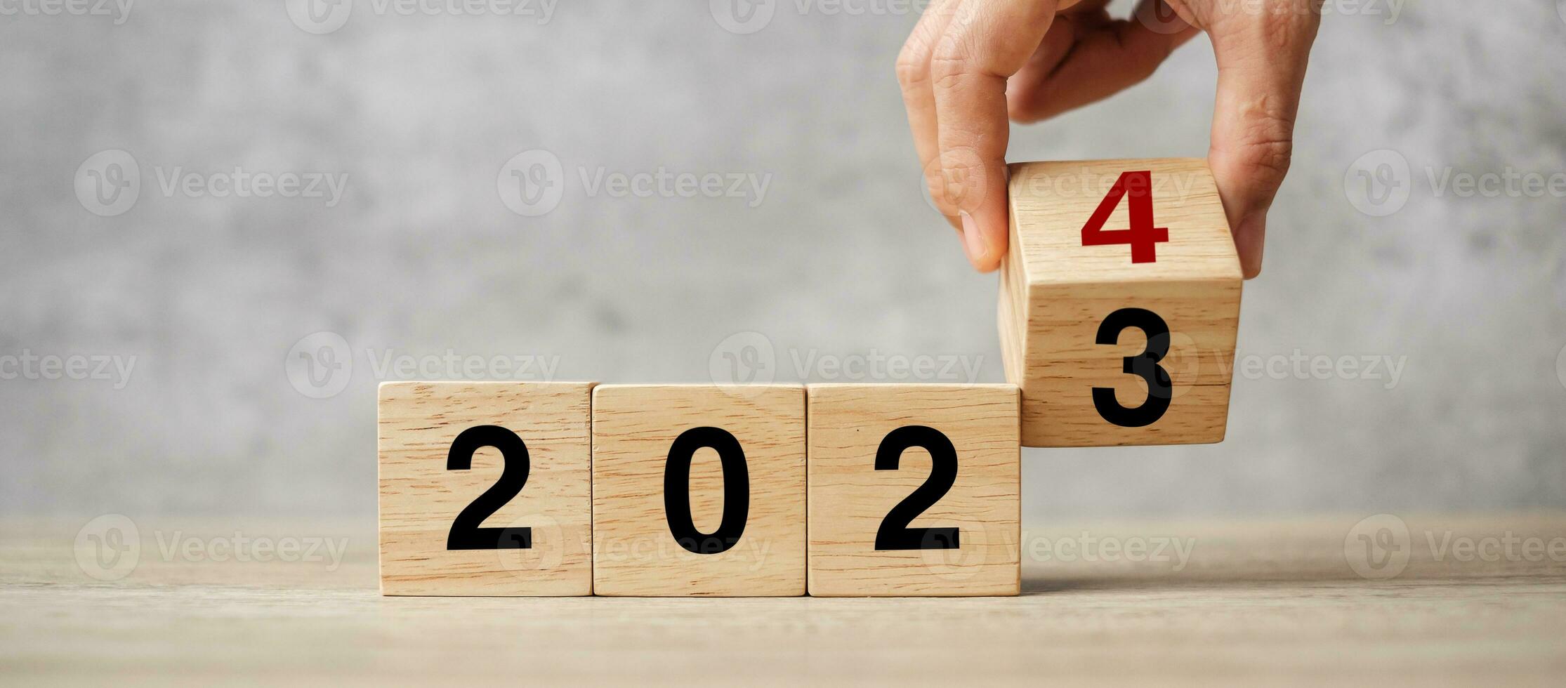 hand flipping block 2023 to 2024 text on table. Resolution, strategy, plan, goal, motivation, reboot, business and New Year holiday concepts photo