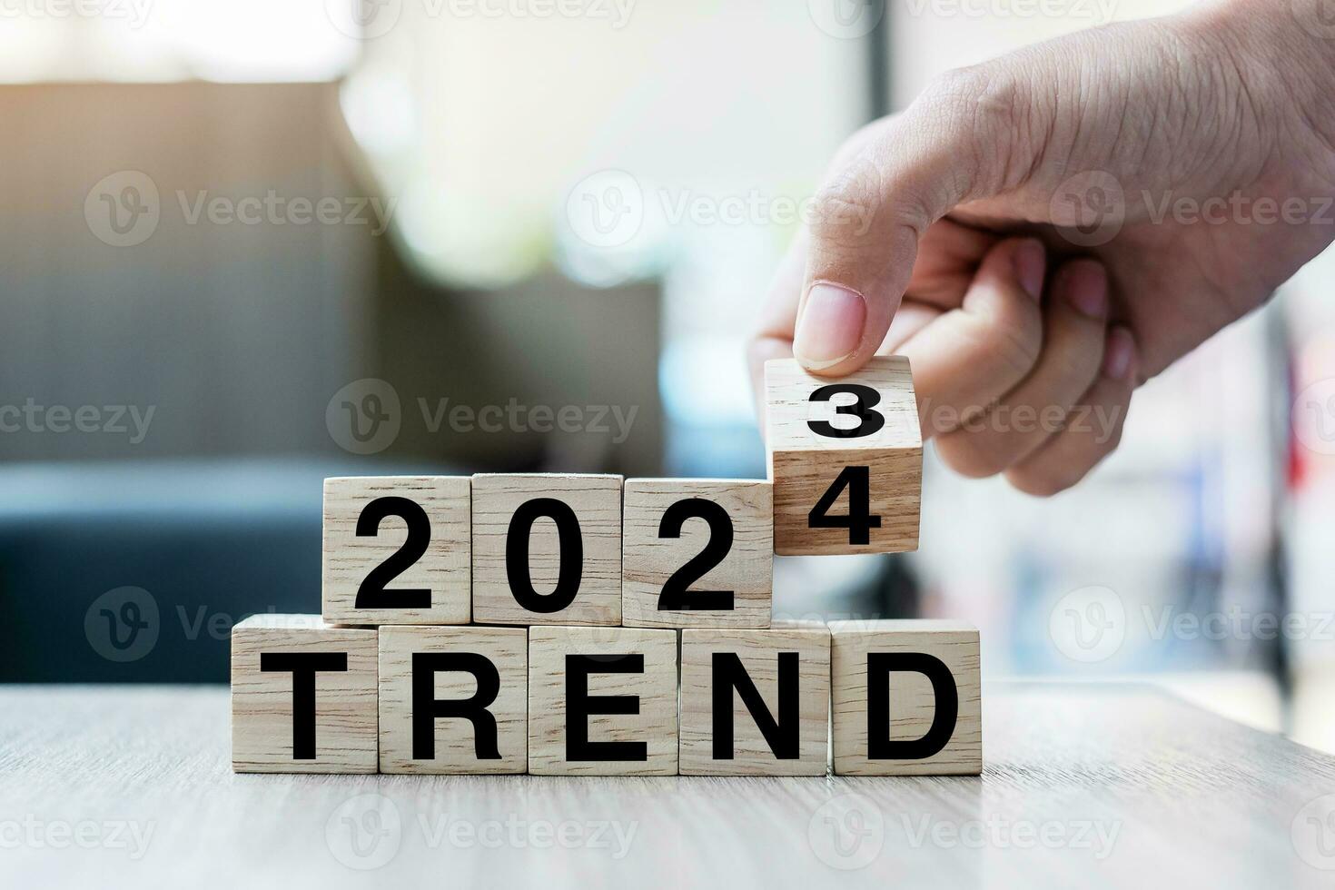 Businessman hand holding wooden cube with flip over block 2023 to 2024 Plans word on table background. Resolution, strategy, solution, goal, business and New Year holiday concepts photo