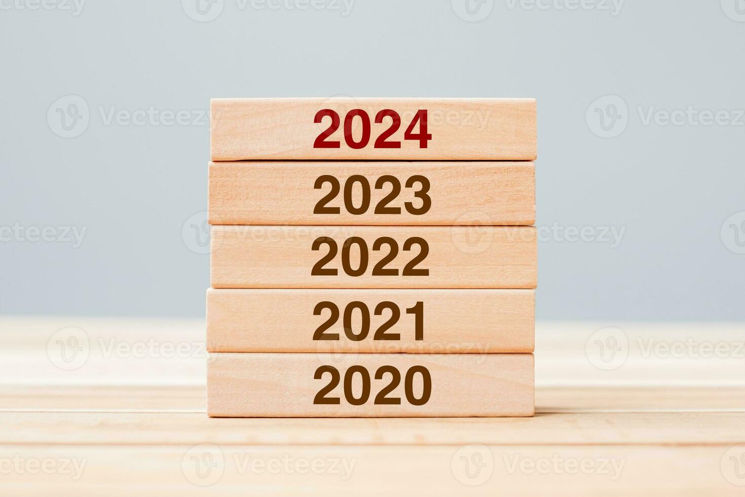 2024 block over 2023 and 2022 wooden building on table background. Business planning, Risk Management, Resolution, strategy, solution, goal, New Year New You and happy holiday concepts photo