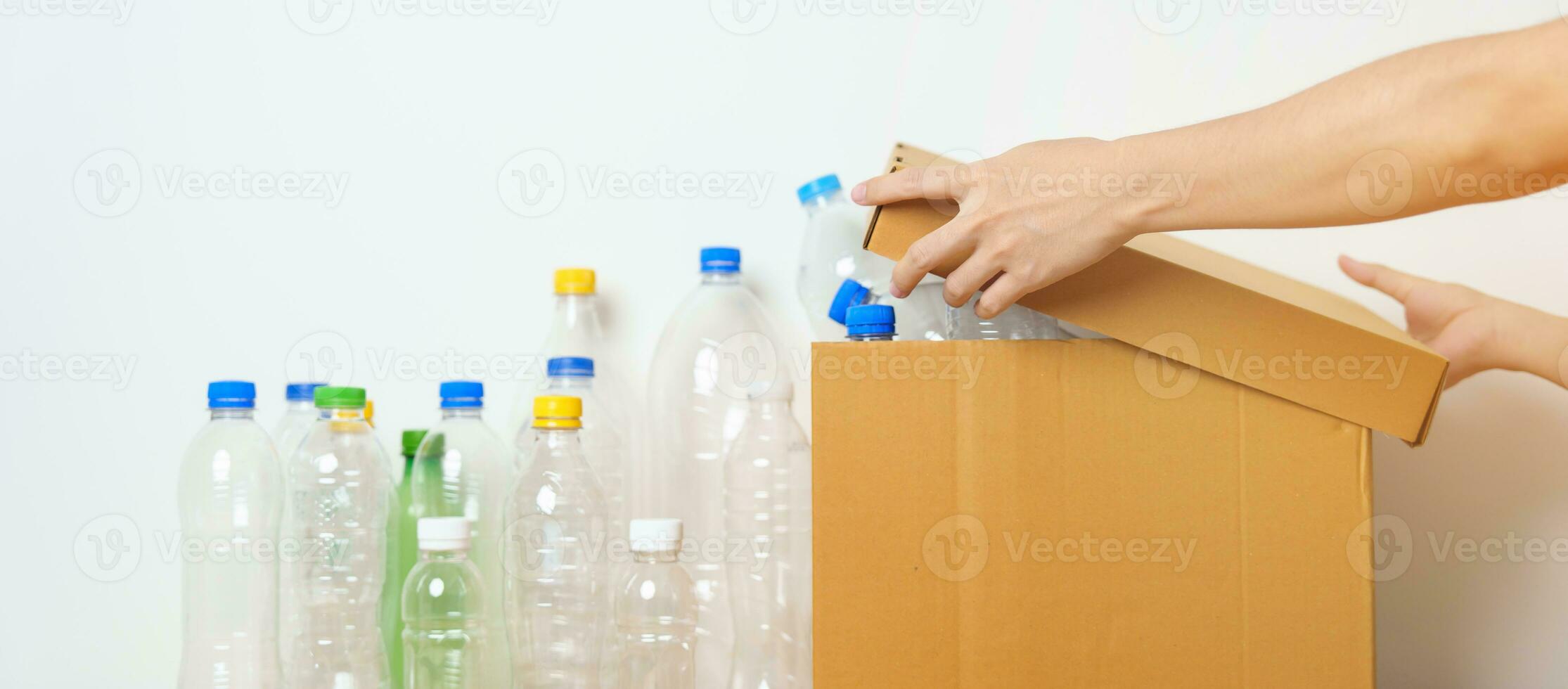 Volunteer keep plastic bottle into paper box at home or office. Hand Sorting Recycle garbage. Ecology, Environmental, pollution, Dispose recycling, waste management and trash Separation concept photo