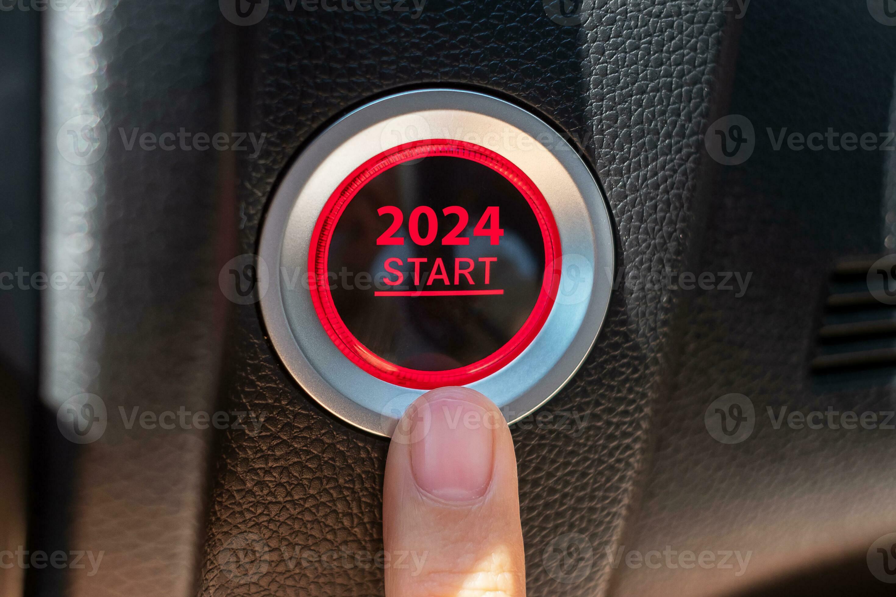 Finger press a car ignition button with 2024 START text inside
