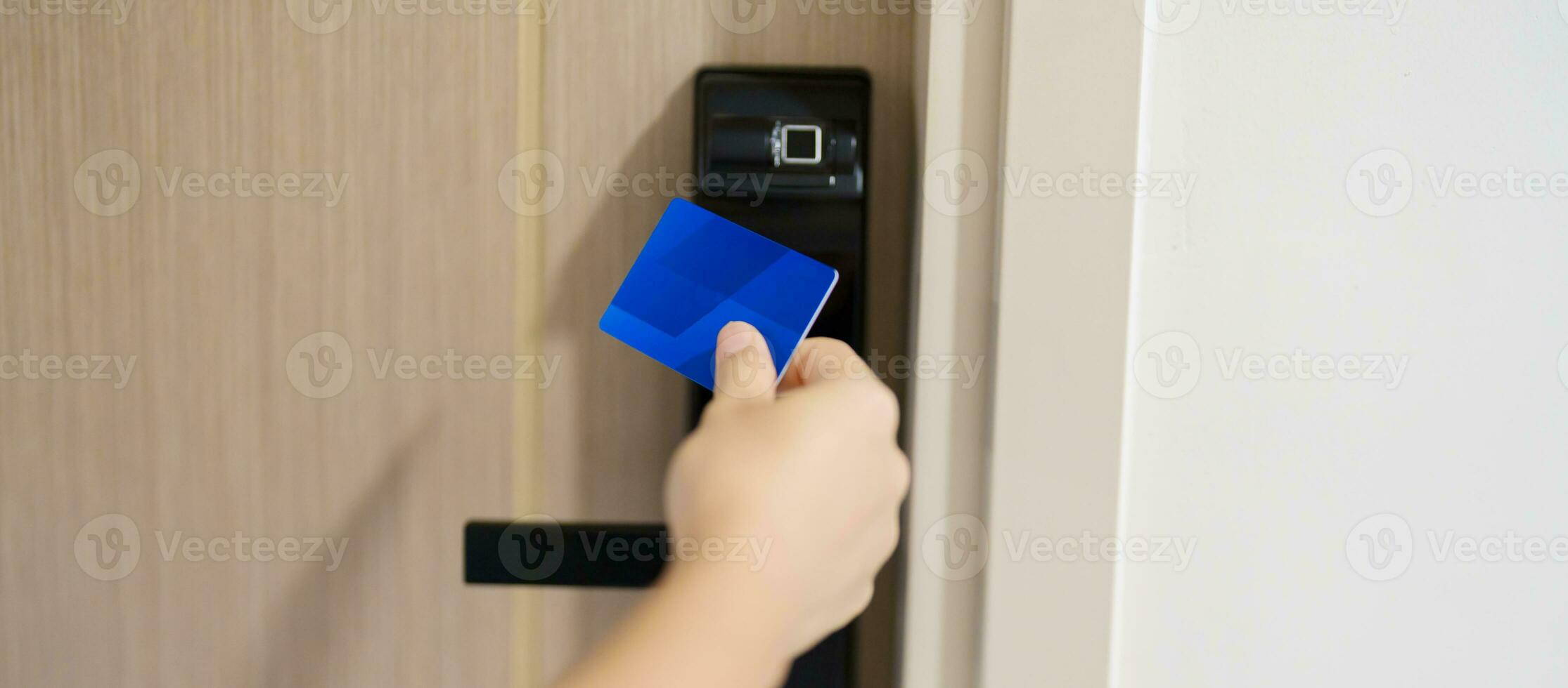 Hand using keycard for smart digital door lock while open or close the door at home or apartment. NFC Technology, Fingerprint scan, PIN number, smartphone and contactless lifestyle concepts photo