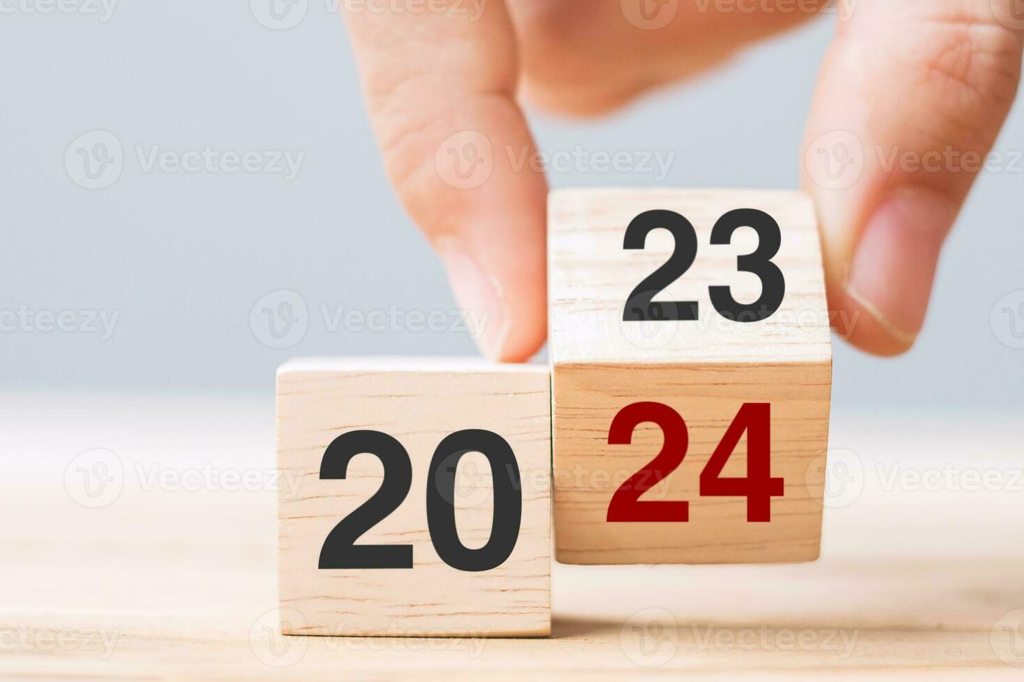 hand flip cube block 2023 to 2024 text on table. Resolution, review, strategy, end year, goal, business and New Year holiday concepts photo