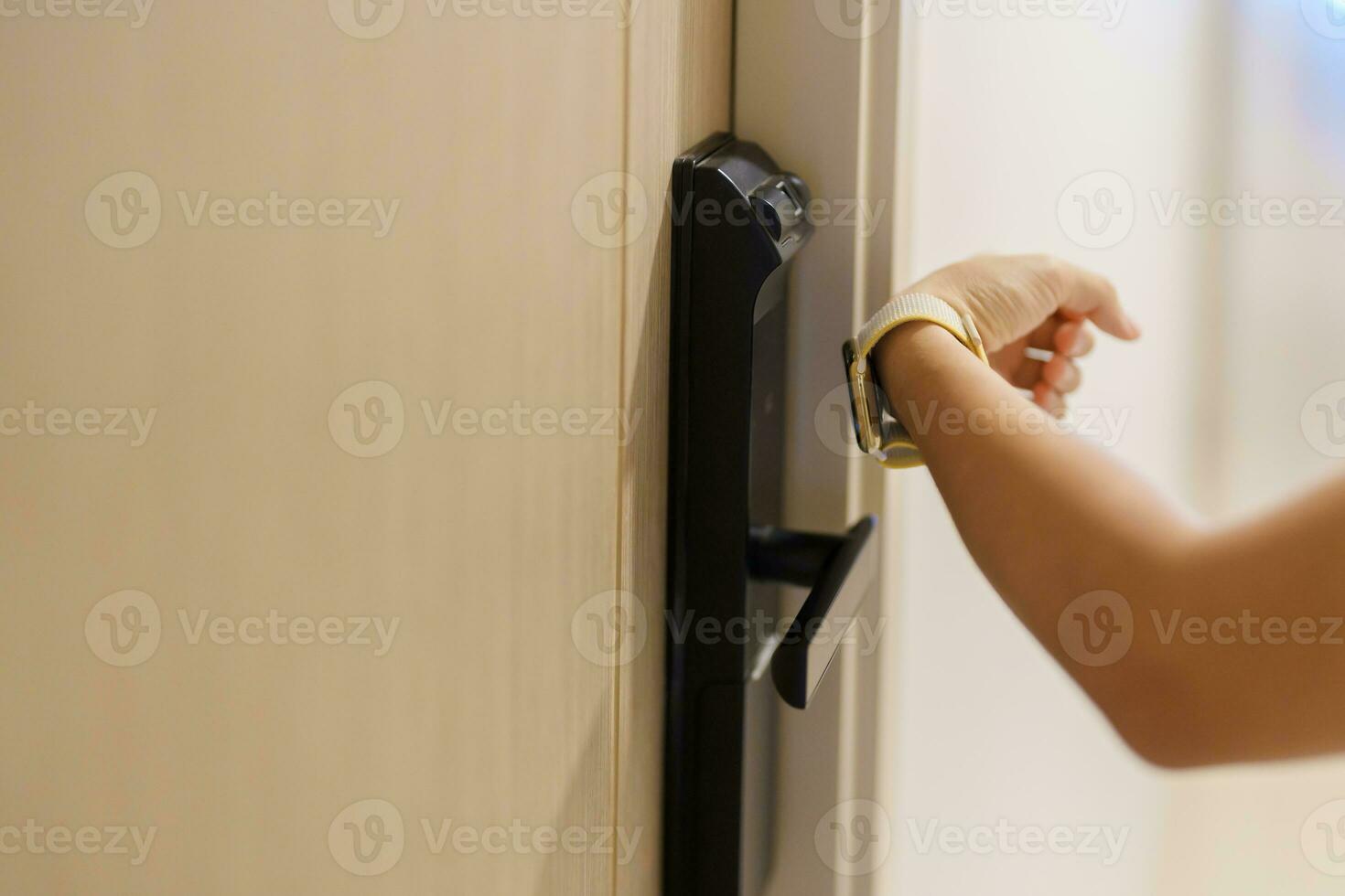 Hand using smartwatch for open digital door lock at home or apartment. NFC Technology, Fingerprint scan, keycard, PIN number, smartphone, electrical and contactless lifestyle concepts photo