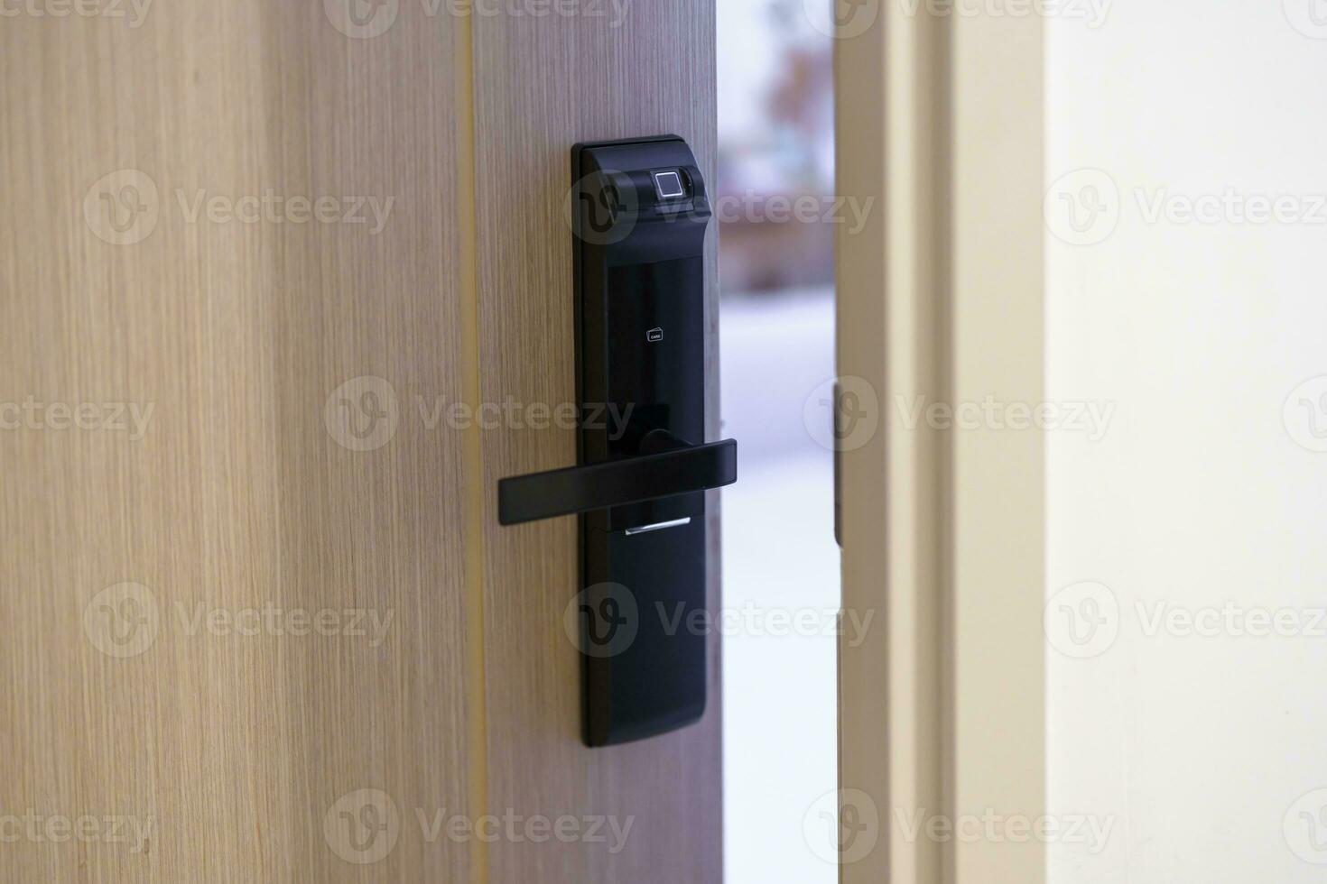 smart digital door lock while open or close the door at home or apartment. NFC Technology, Fingerprint scan, keycard, PIN number, smartphone, electrical and contactless lifestyle concepts photo