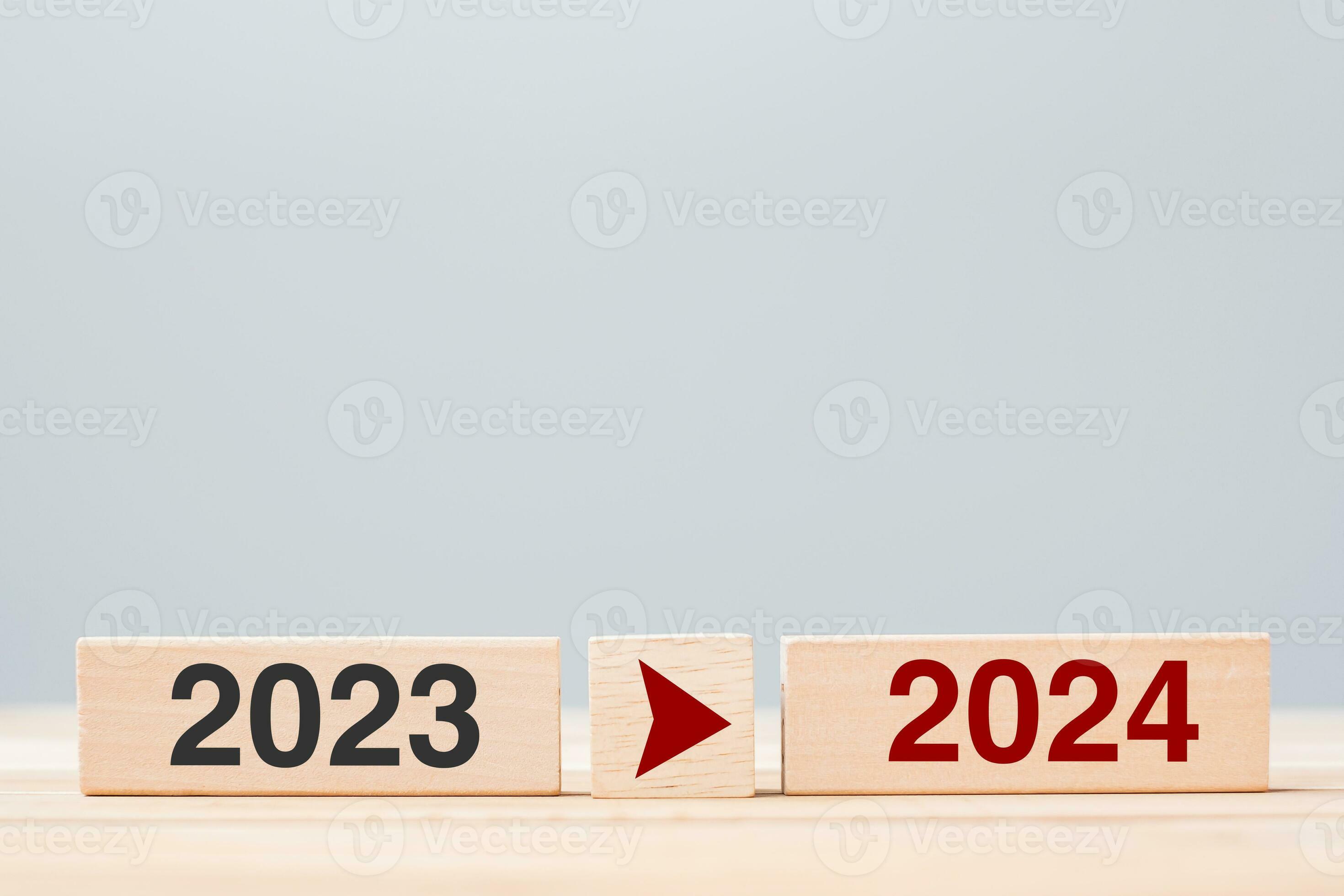 2024 and 2023 wooden block on table background. Resolution, strategy