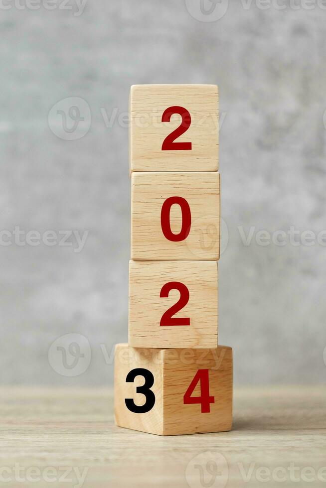 block flipping 2023 to 2024 text on table. Resolution, strategy, plan, goal, motivation, reboot, business and New Year holiday concepts photo