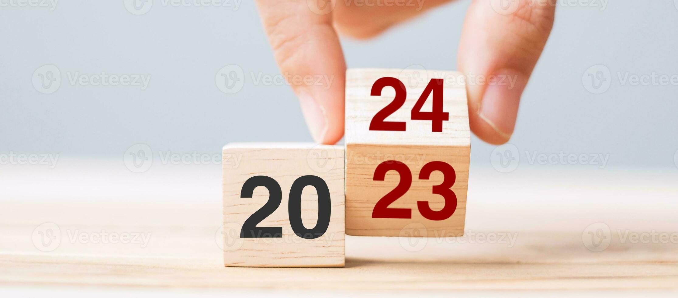 hand flip cube block 2023 to 2024 text on table. Resolution, review, strategy, end year, goal, business and New Year holiday concepts photo