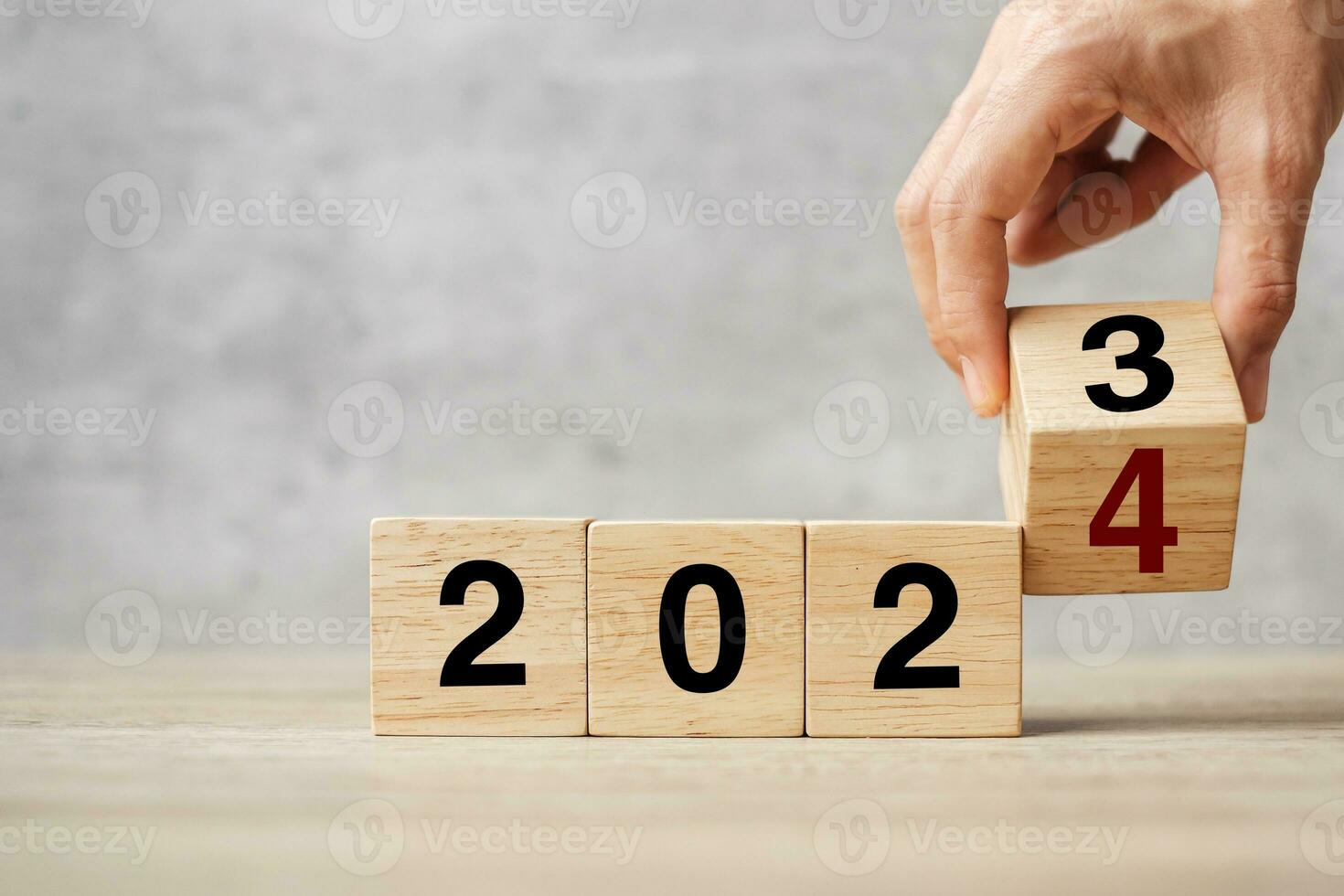 hand flipping block 2023 to 2024 text on table. Resolution, strategy, plan, goal, motivation, reboot, business and New Year holiday concepts photo