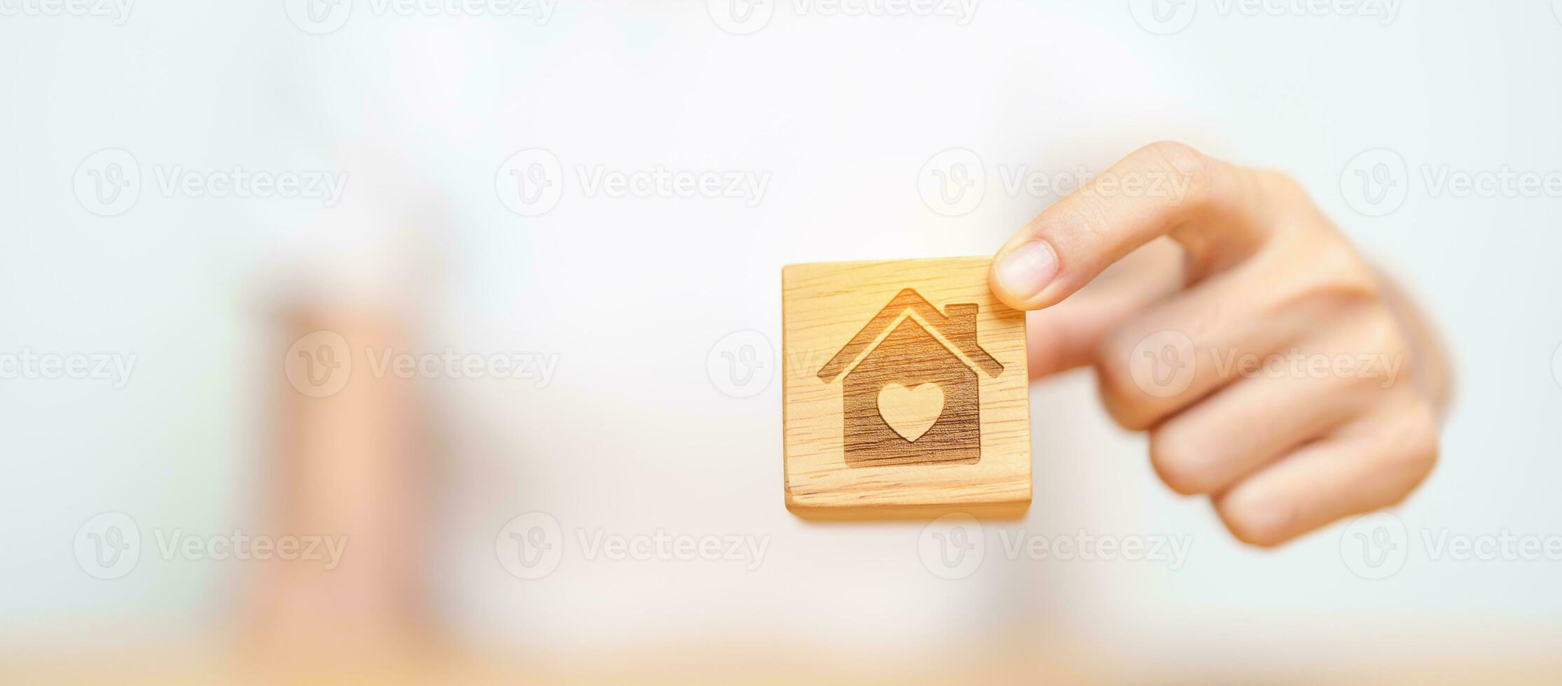 Hand Holding Home with Heart block. Property investment, House Mortgage, Real Estate tax, homeless, donation, Financial and happy family concepts photo