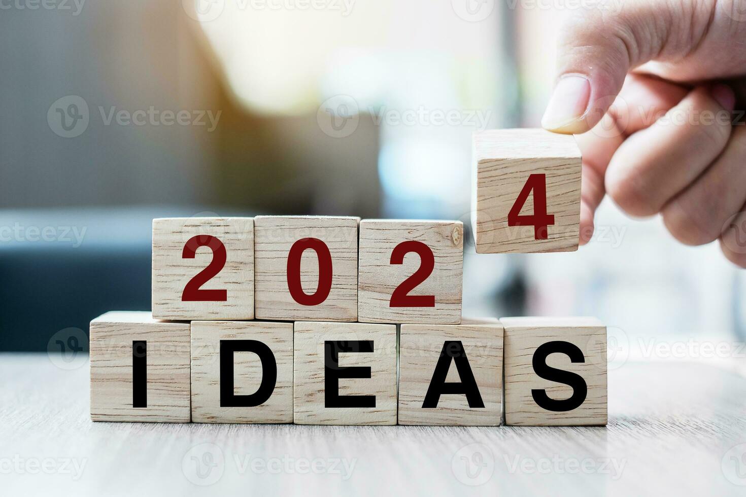 Businessman hand holding wooden cube with flip over block 2023 to 2024 Plans word on table background. Resolution, strategy, solution, goal, business and New Year holiday concepts photo