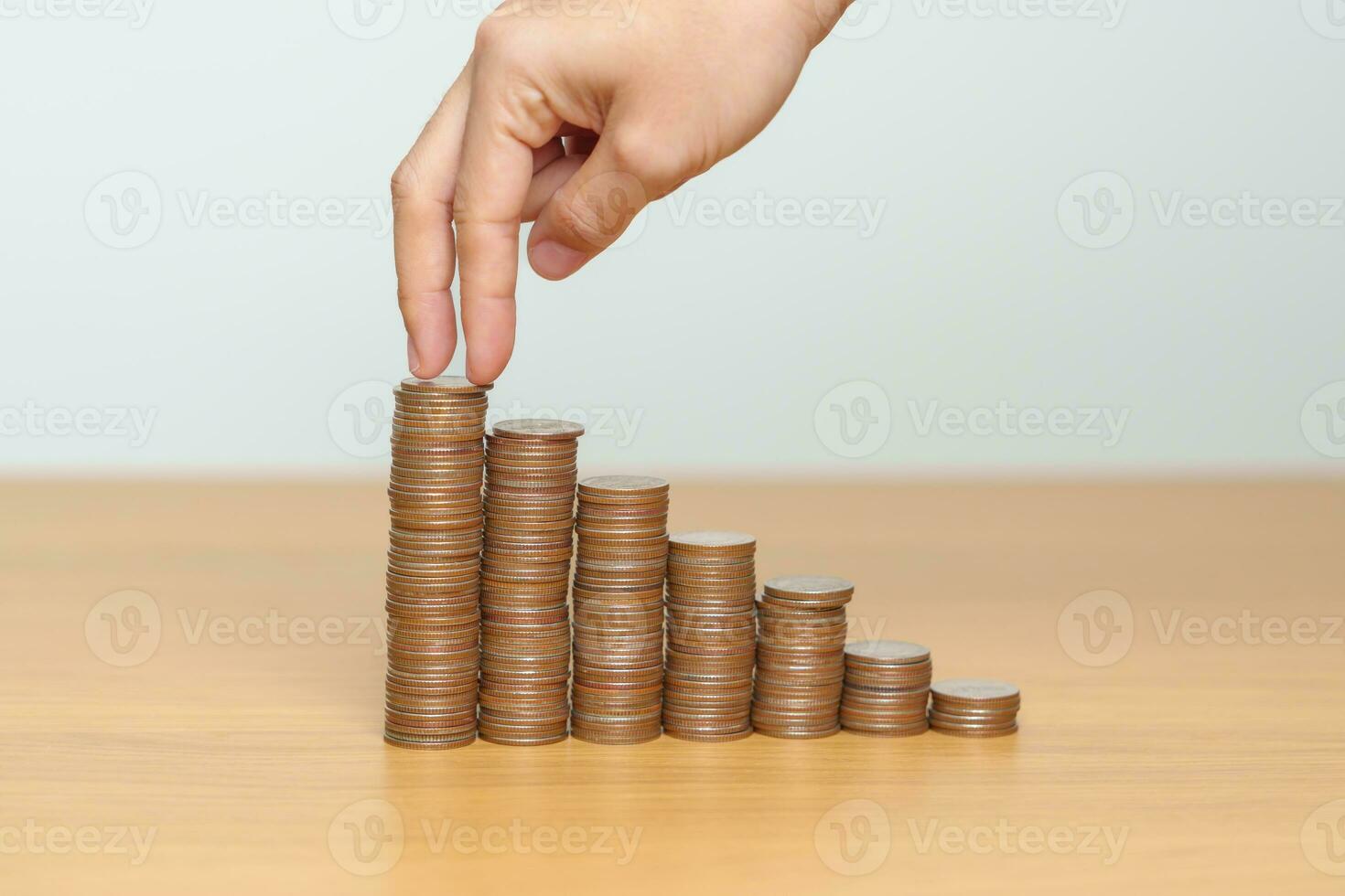Money Saving for Future Plan, Retirement fund, Pension, Investment, Wealth, Salary and Financial concepts. hand step up coin on table, Money Counting and stack arrangement for Growth photo