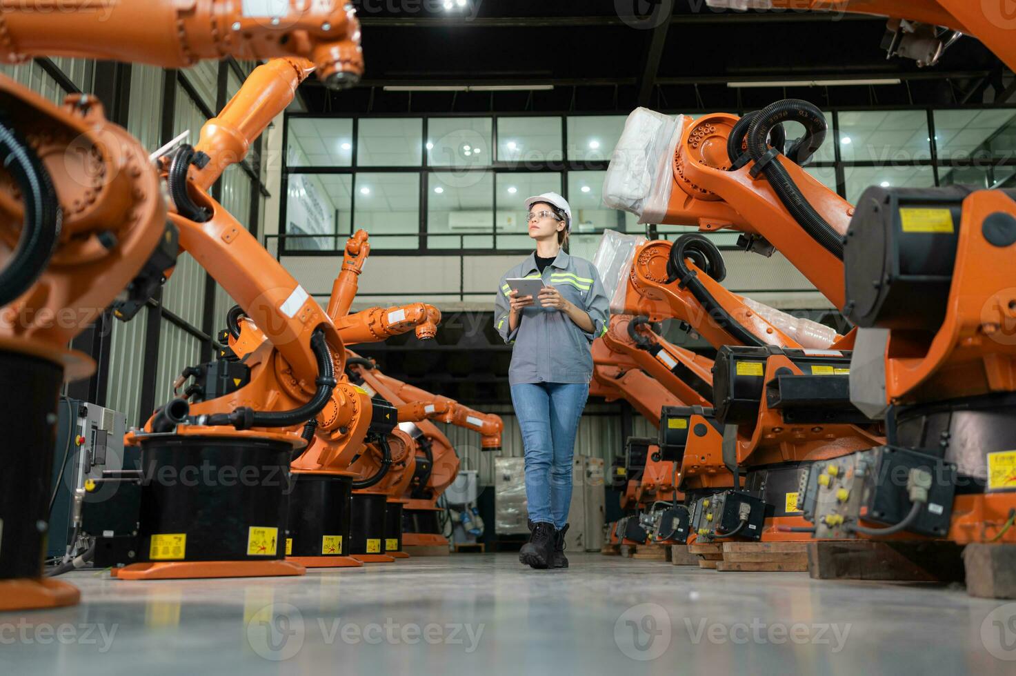 A female auditor Inspected to account for the company's robot assets that were brought to the warehouse before delivering to customers. photo