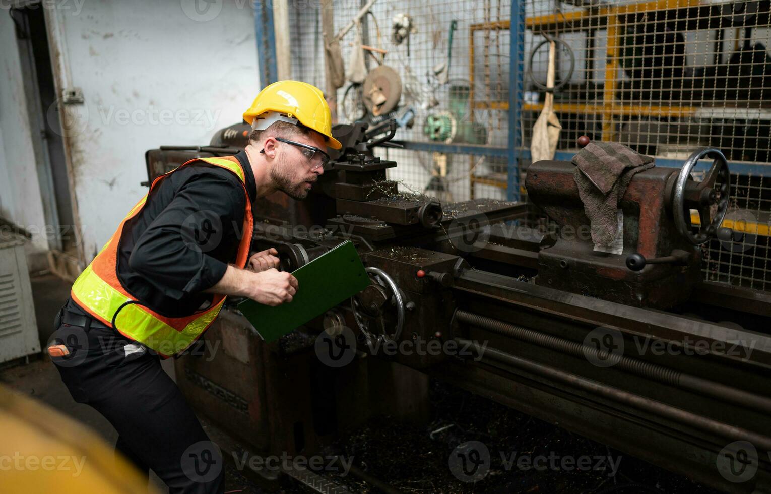 Mechanical engineers enter the old machinery warehouse to inspect and repair used machinery with the warehouse's personnel. photo