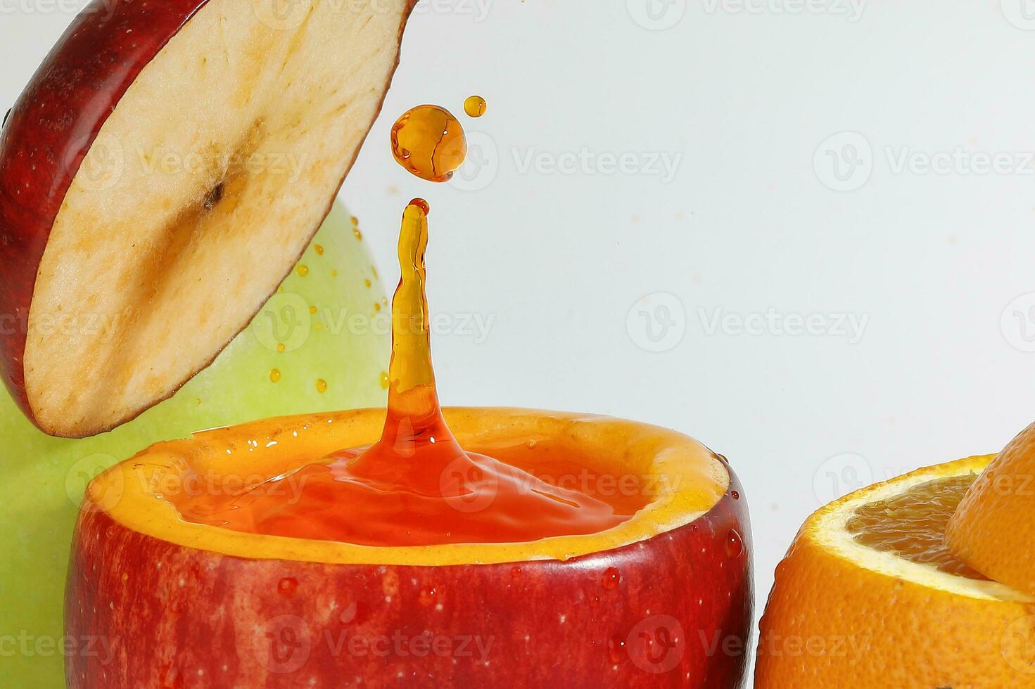 Red Apple real juice splash in fresh half cut hollow cup fruit photo