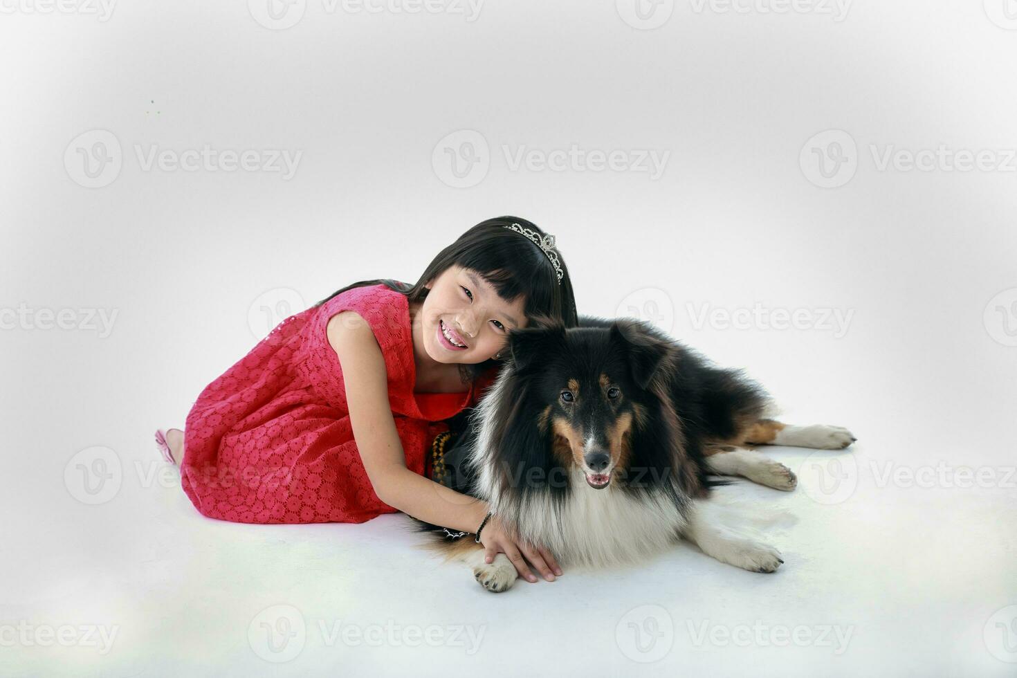 Southeast Asian young girl child with pet dog playing petting happy photo