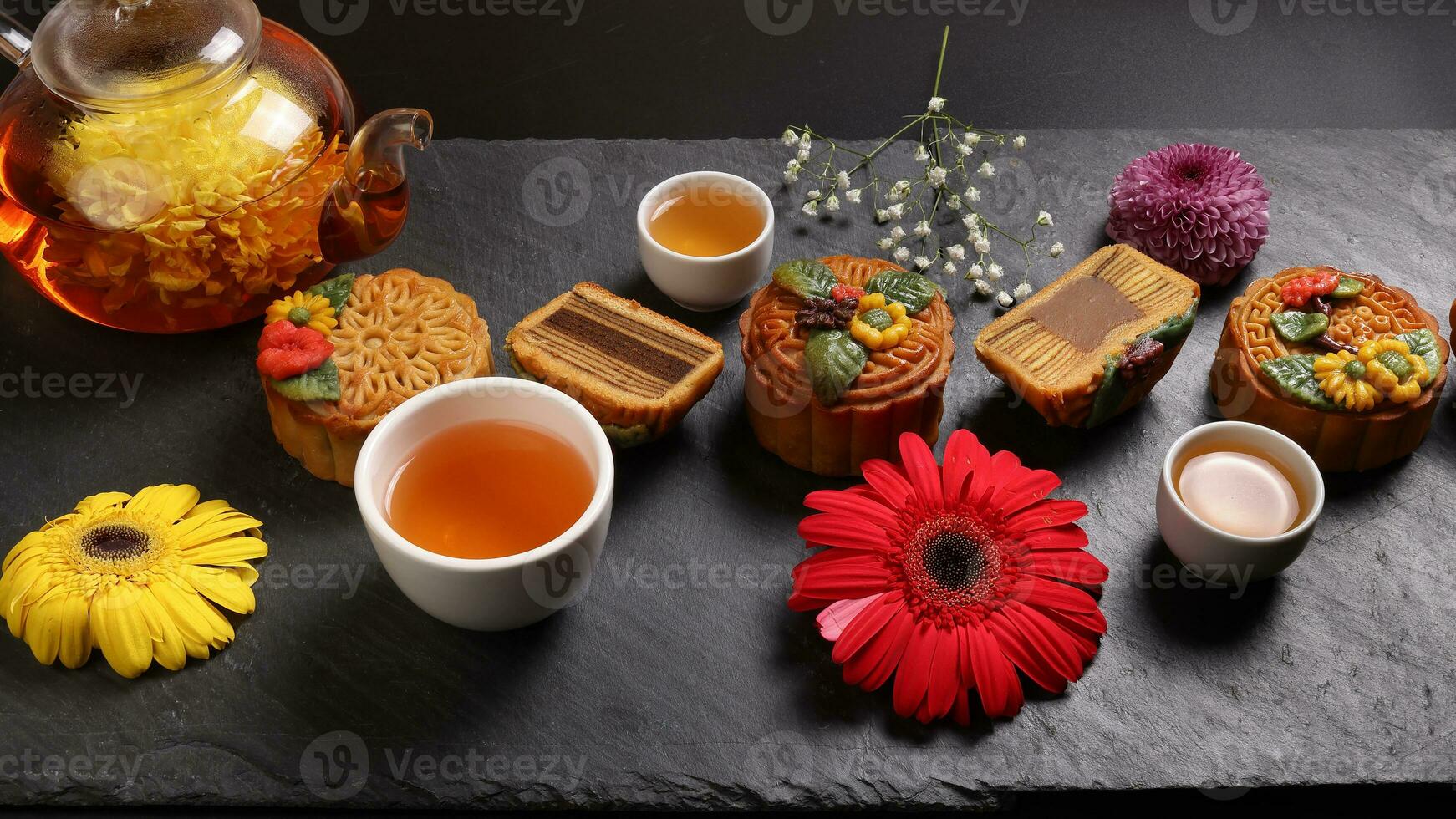 Colourful flower decorated mooncake Chinese mid autumn festival black slate stone background white teacup glass teapot daisy chrysanthemum mum rose baby breath flower red yellow pink purple violet photo