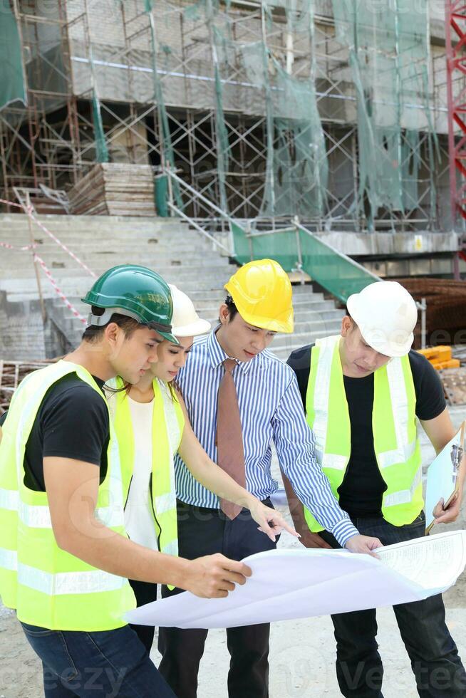 South East Asian young Malay Chinese man woman wearing safely helmet construction site work photo