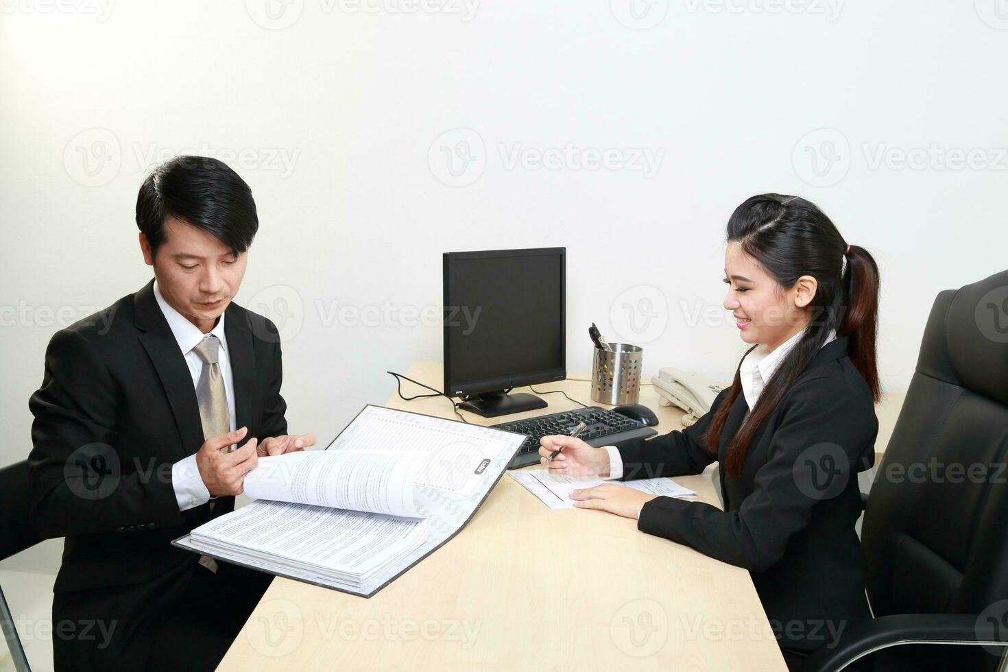 Young Asian man woman wearing business office suit chair table computer white background photo