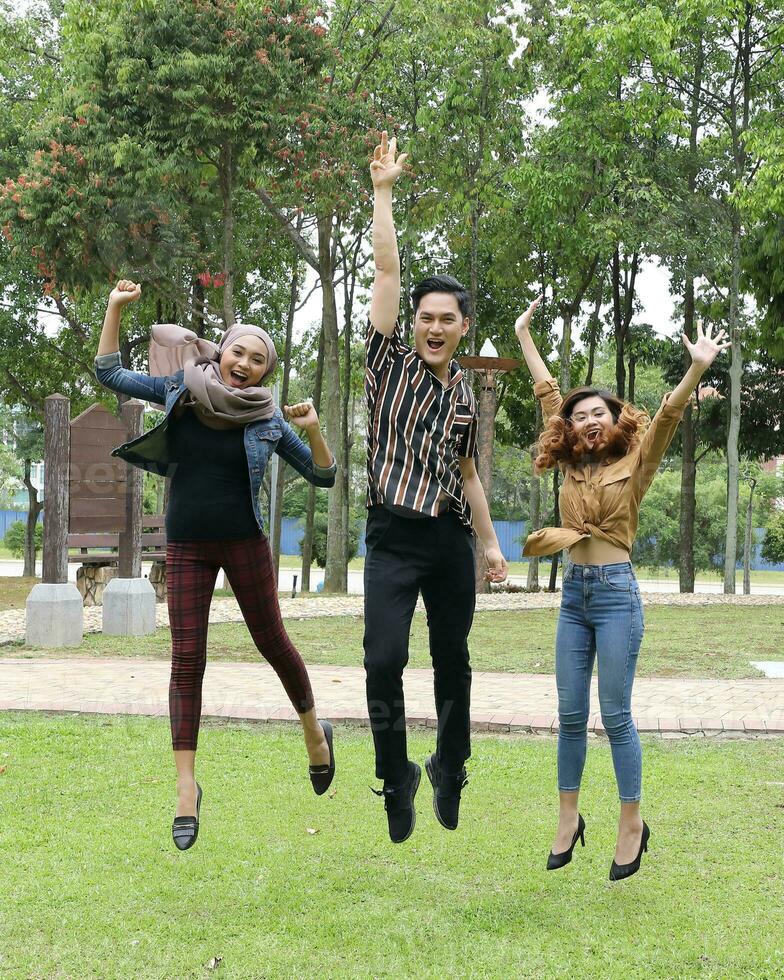 Young Asian different ethnic malay chinse  man woman activity lifestyle student educating job business jump in air photo