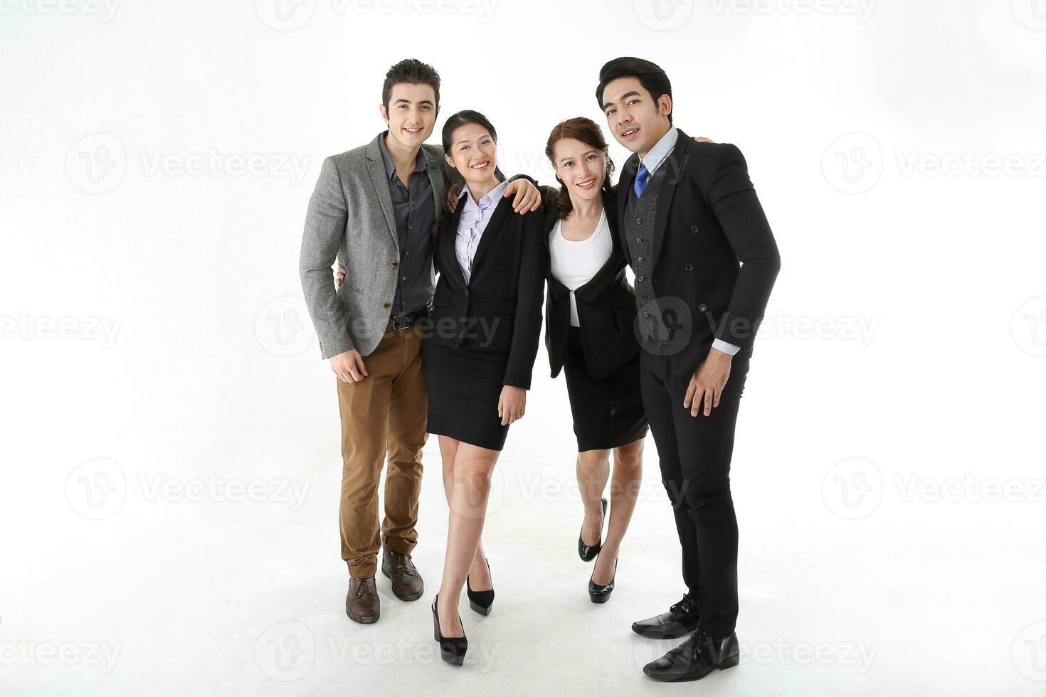 Southeast Asian middle eastern Caucasian young office business man woman wearing suit stand hand on shoulder unity togetherness confident happy success expression on white studio background photo