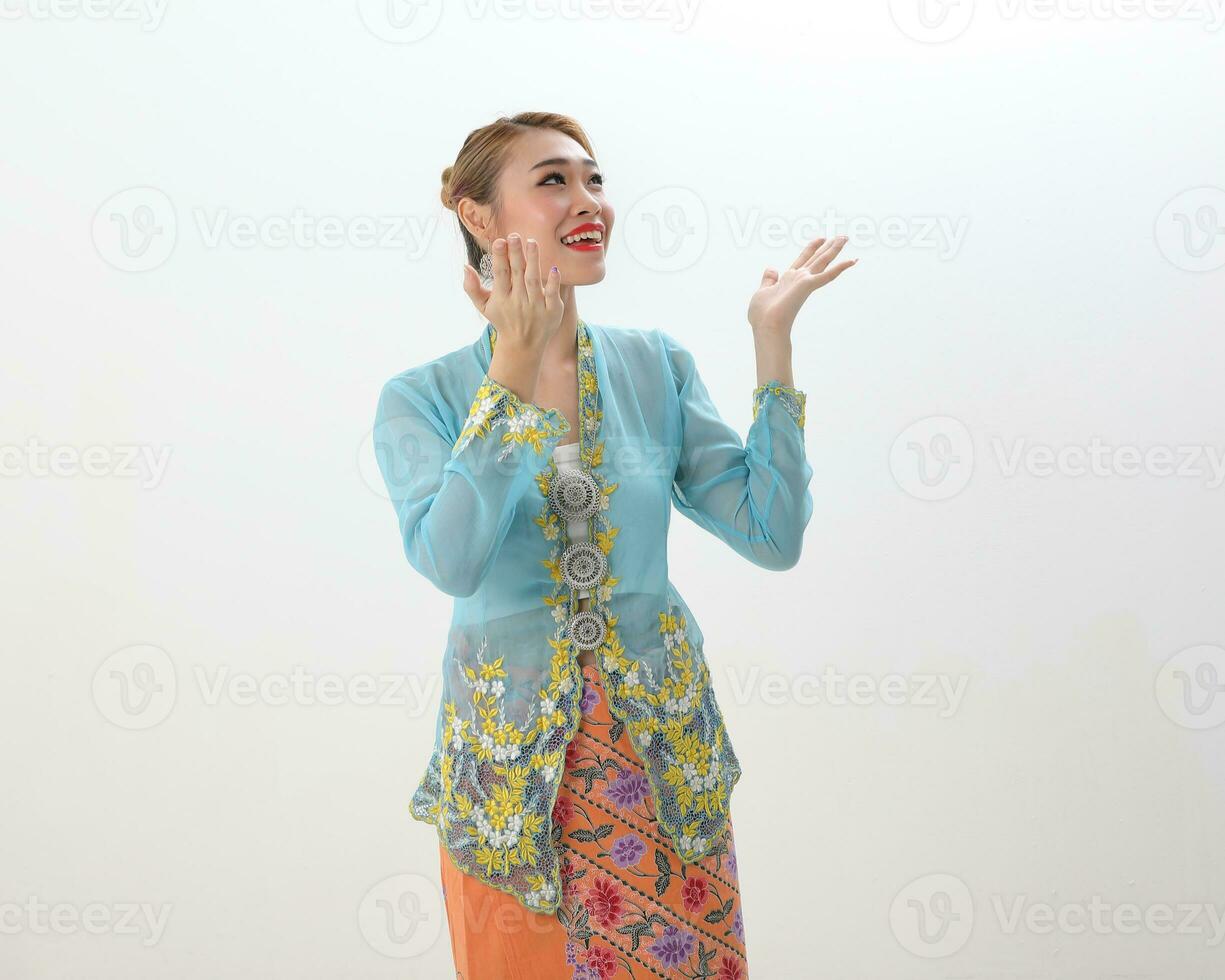 Asian woman traditional blue orange kebaya sharong on white  background happy surprised look up photo