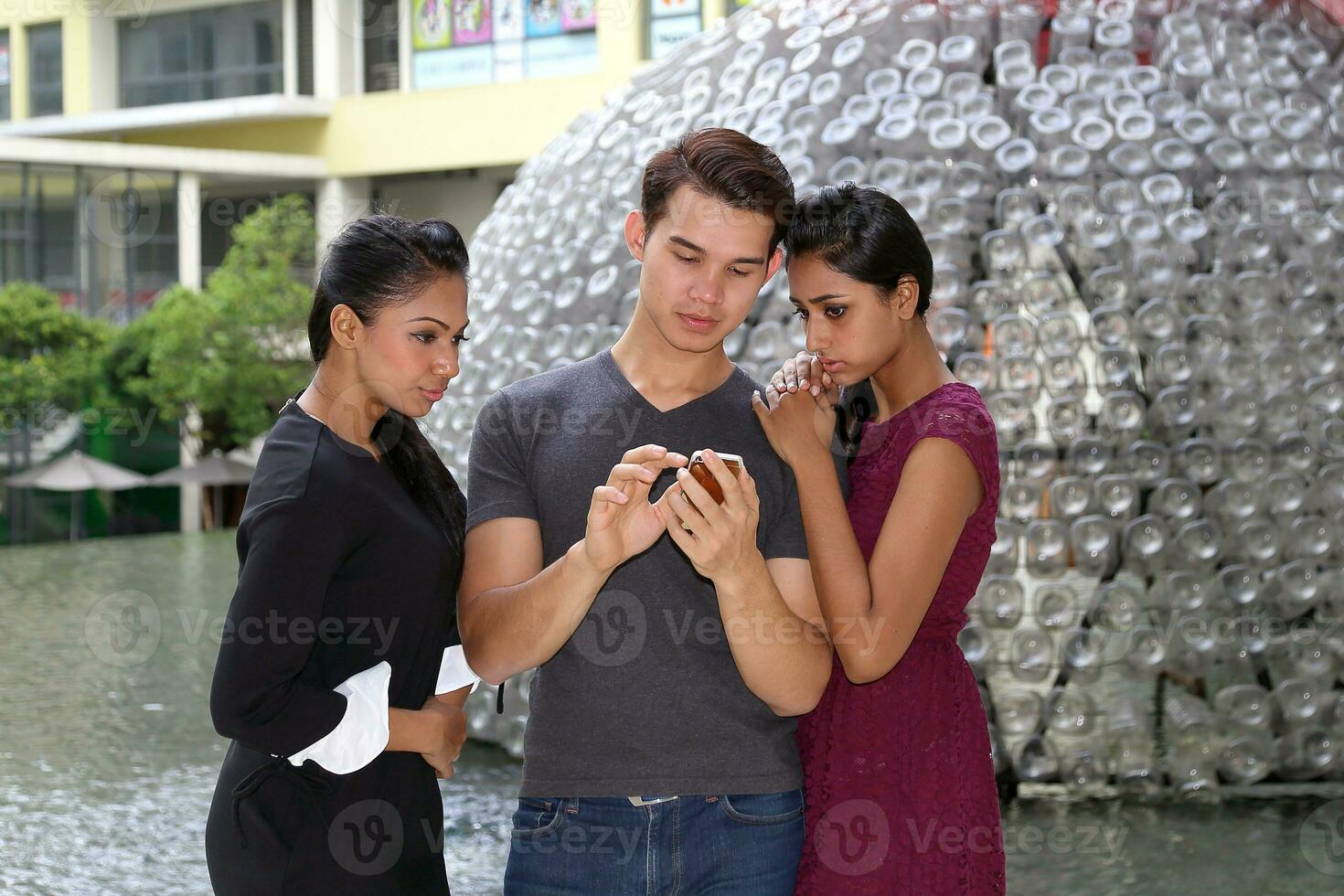 Asian young attractive confident man checking phone woman pose happy hand on shoulder fiend student colleague photo
