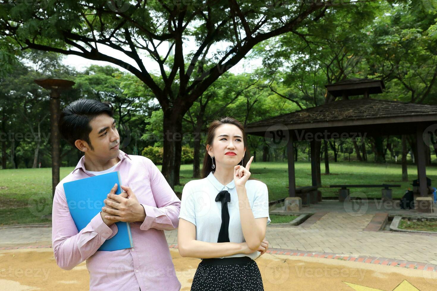 Young asian malay chinese man woman outdoor park  book file folder laptop computer phone sit stand study mingle photo