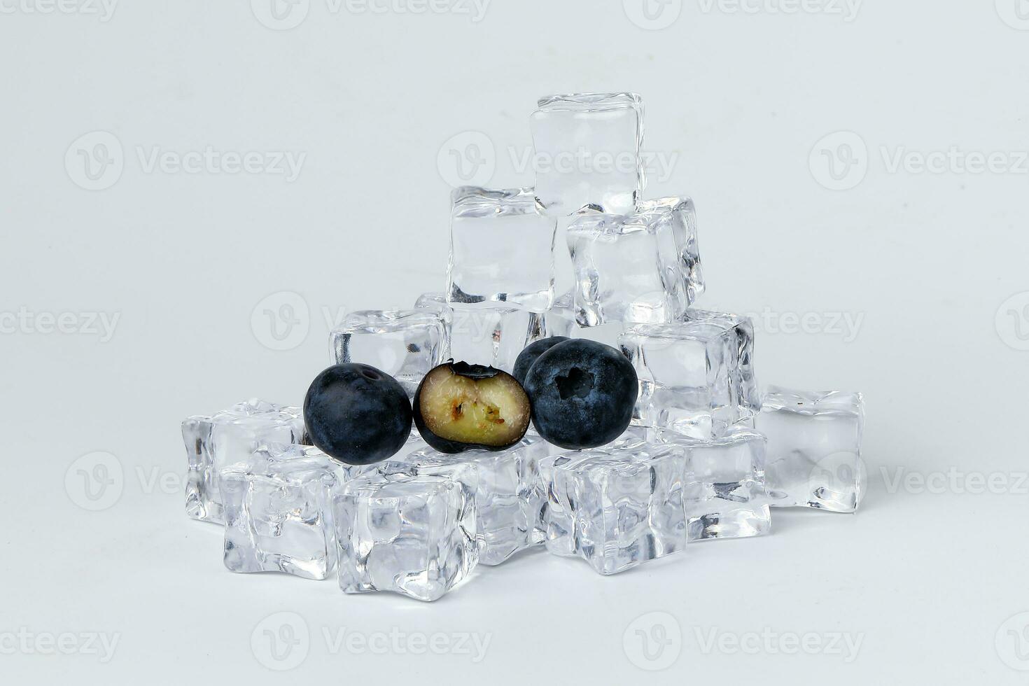 Blueberry black ice cube on white background photo