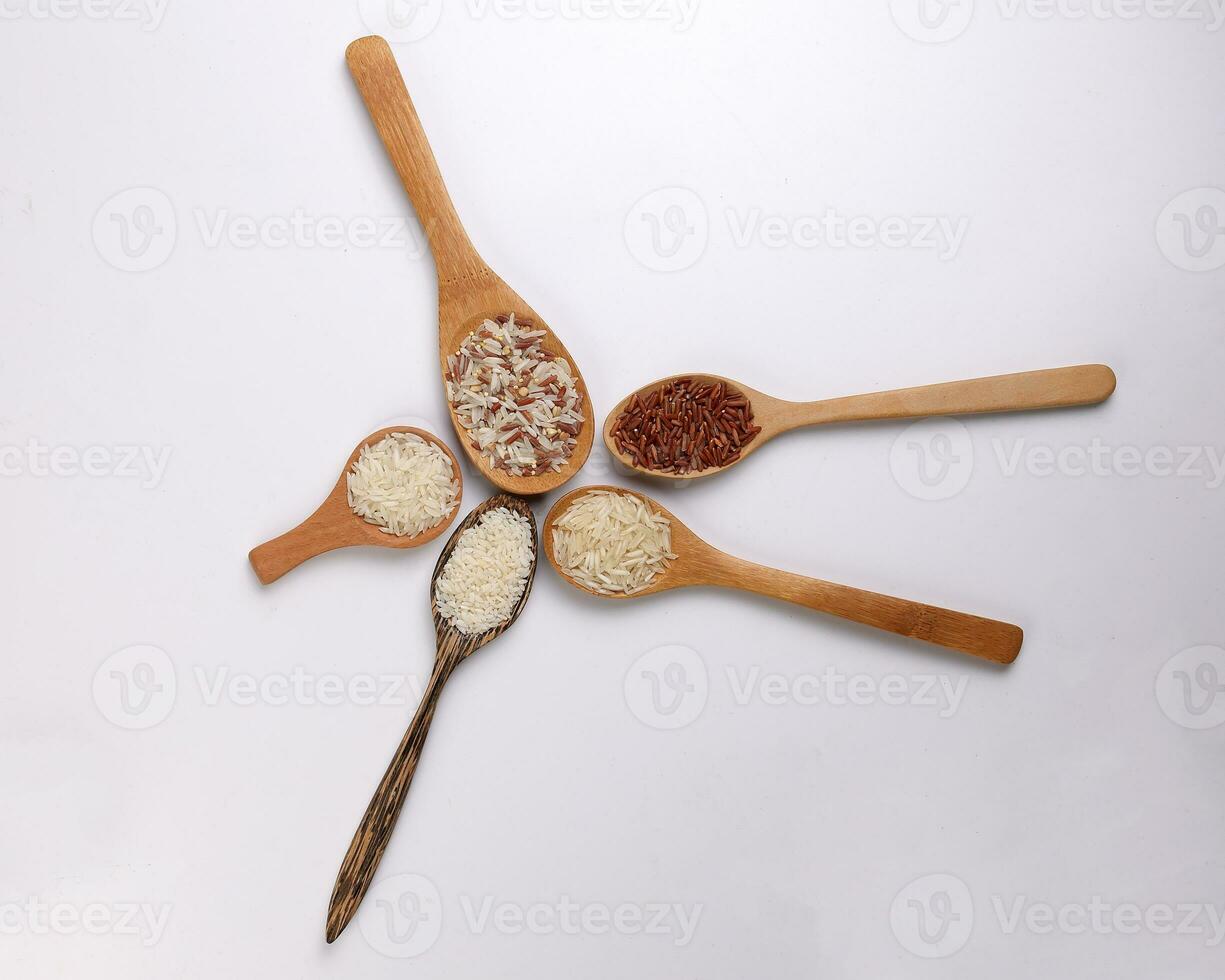 Long grain basmati medium grain jasmine short grain pilaf polau risotto brown low glycaemic index gi rice in wooden spoon on white background copy text space top flat lay view photo