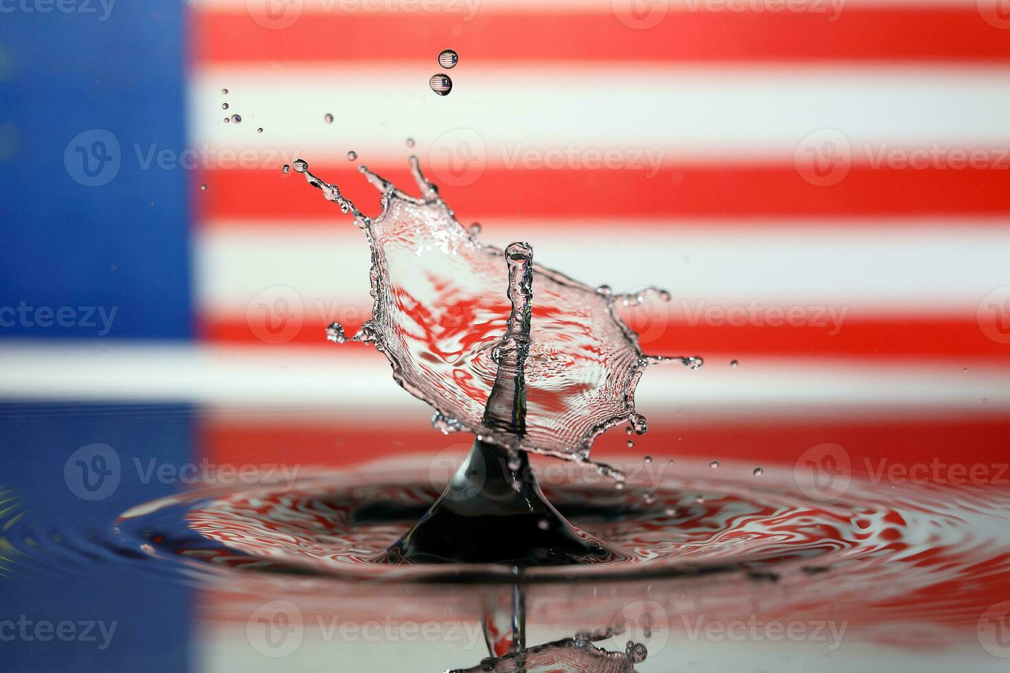 Water droplet drop splash collision dripping pillar Malaysia Flag reflection refraction independence country patriot photo