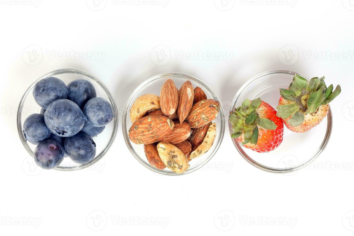 Blueberry Strawberry Herb Spice Almond Cashew Nut in glass bowl on white background photo