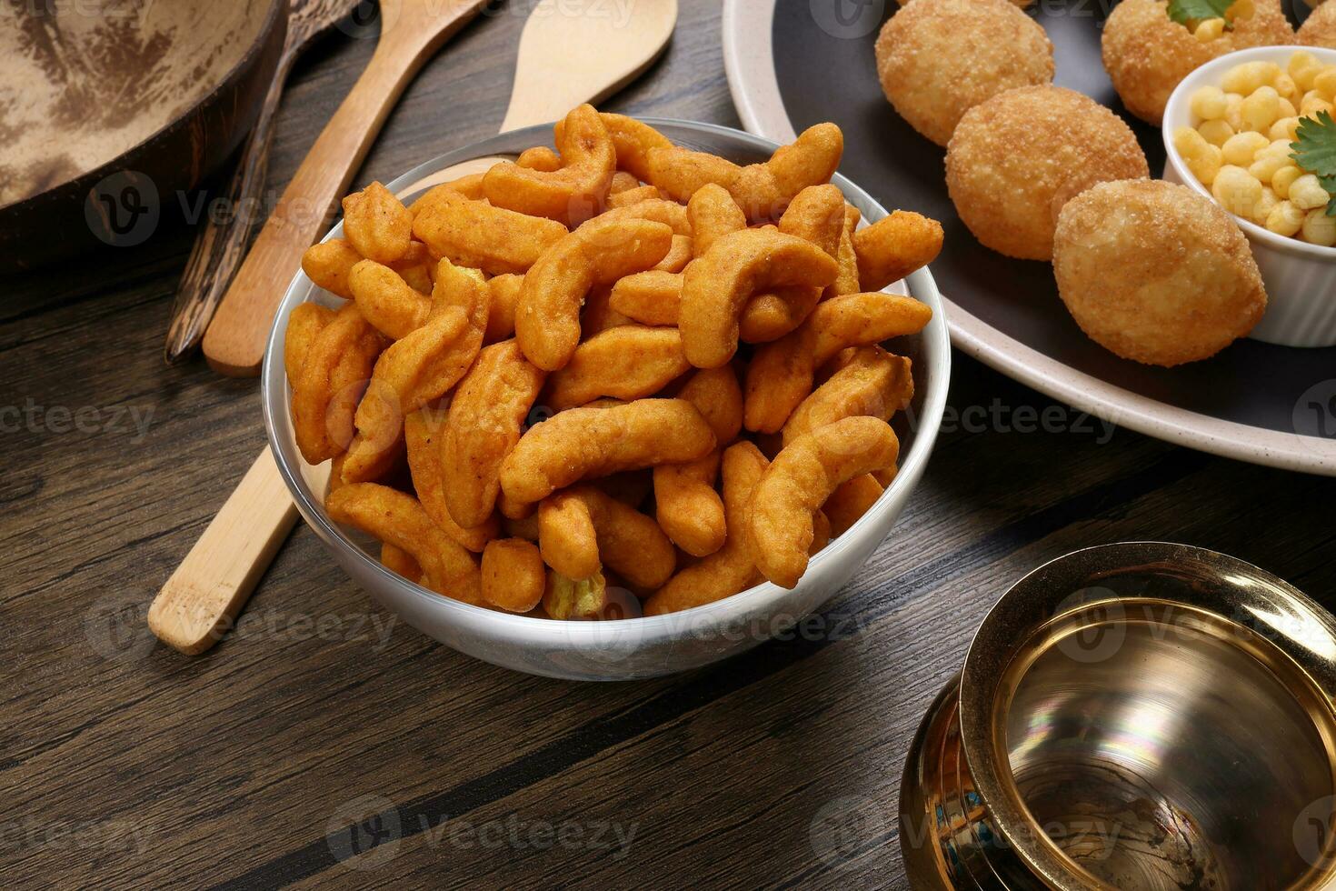 Deep fried battered onion pakoda slightly curly crispy spicy ready to eat snack photo