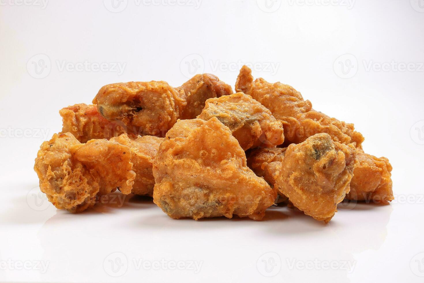 Light battered deep fried chicken variety mix pieces pile on white