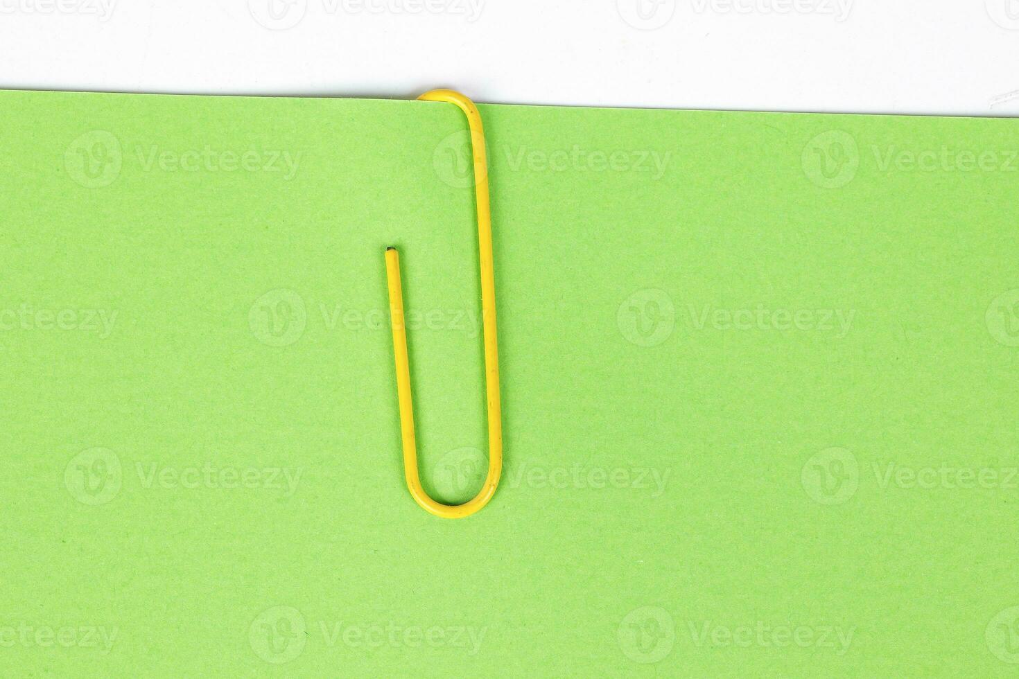 Paper clip holding on blank colour paper text copy space note photo