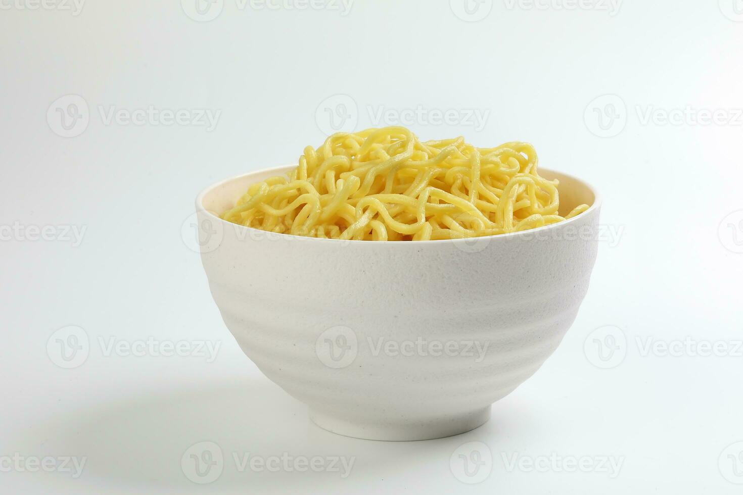 Fresh yellow egg noodle in bowl on whit background photo