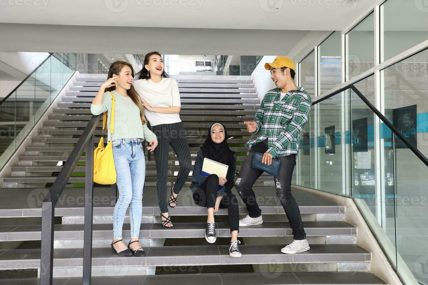 Young asian malay chinese man woman indoor stair corridor campus book file folder laptop computer phone sit stand study mingle photo