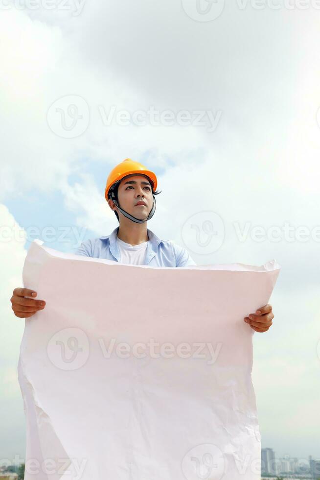 South east Asian construction worker engineer management at construction site hard safety hat helmet photo