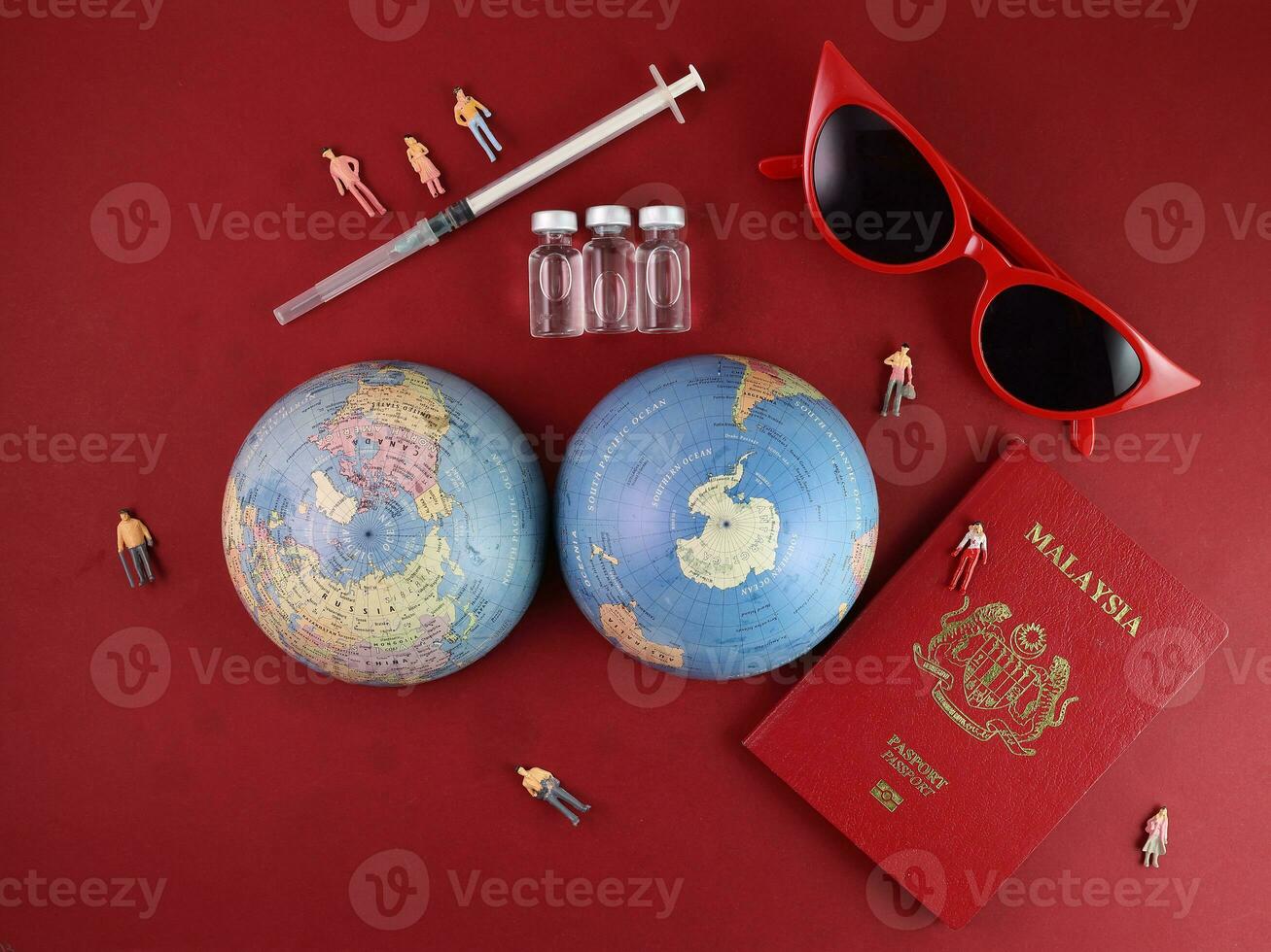Vaccine passport Malaysia red sunglass world atlas globe map north south pole on red paper background world travel tour vacation mini human figures medical needle syringe bottle photo