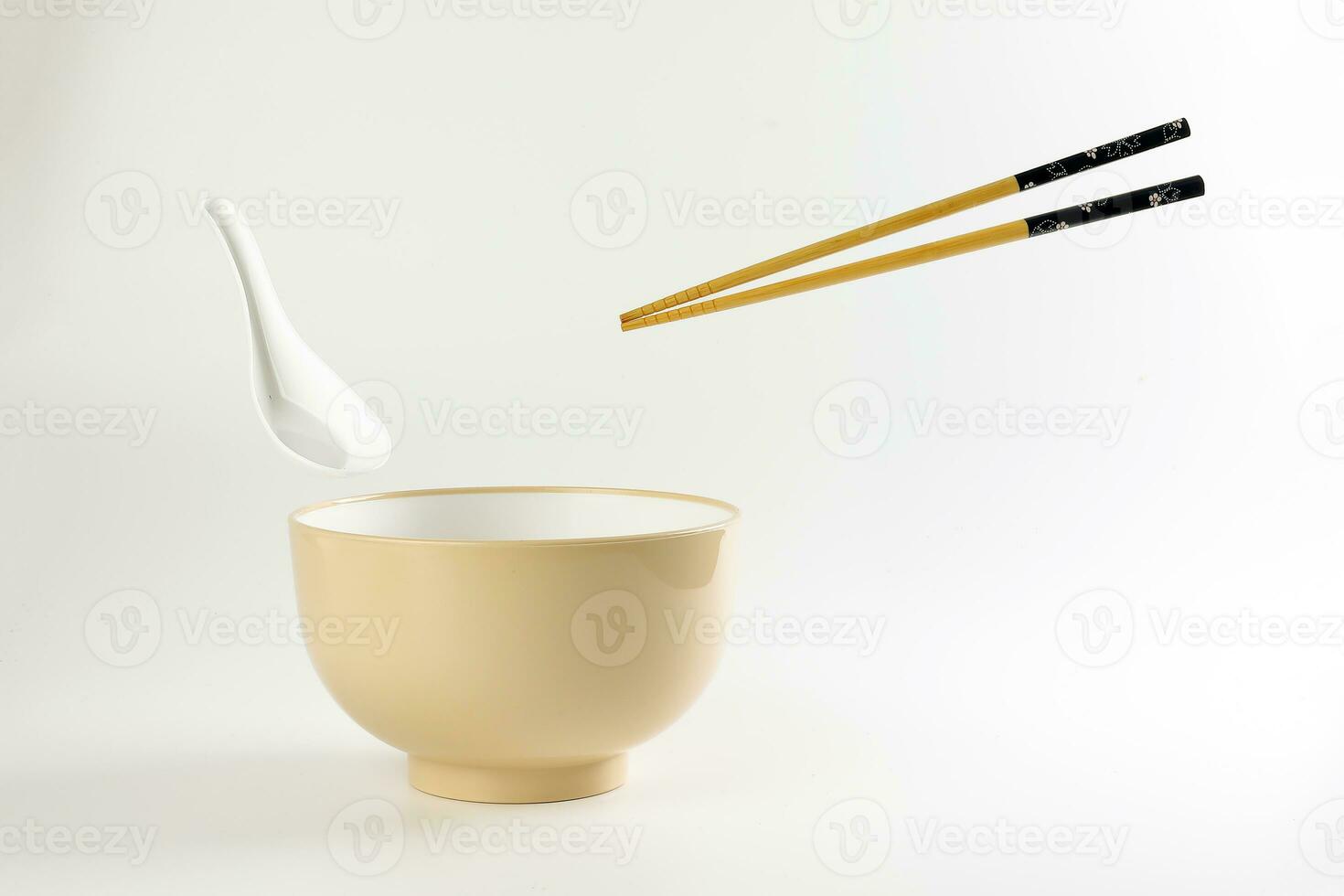 Empty oriental Japanese Chinese soup bowl spoon chopstick elevated flying in air off white photo