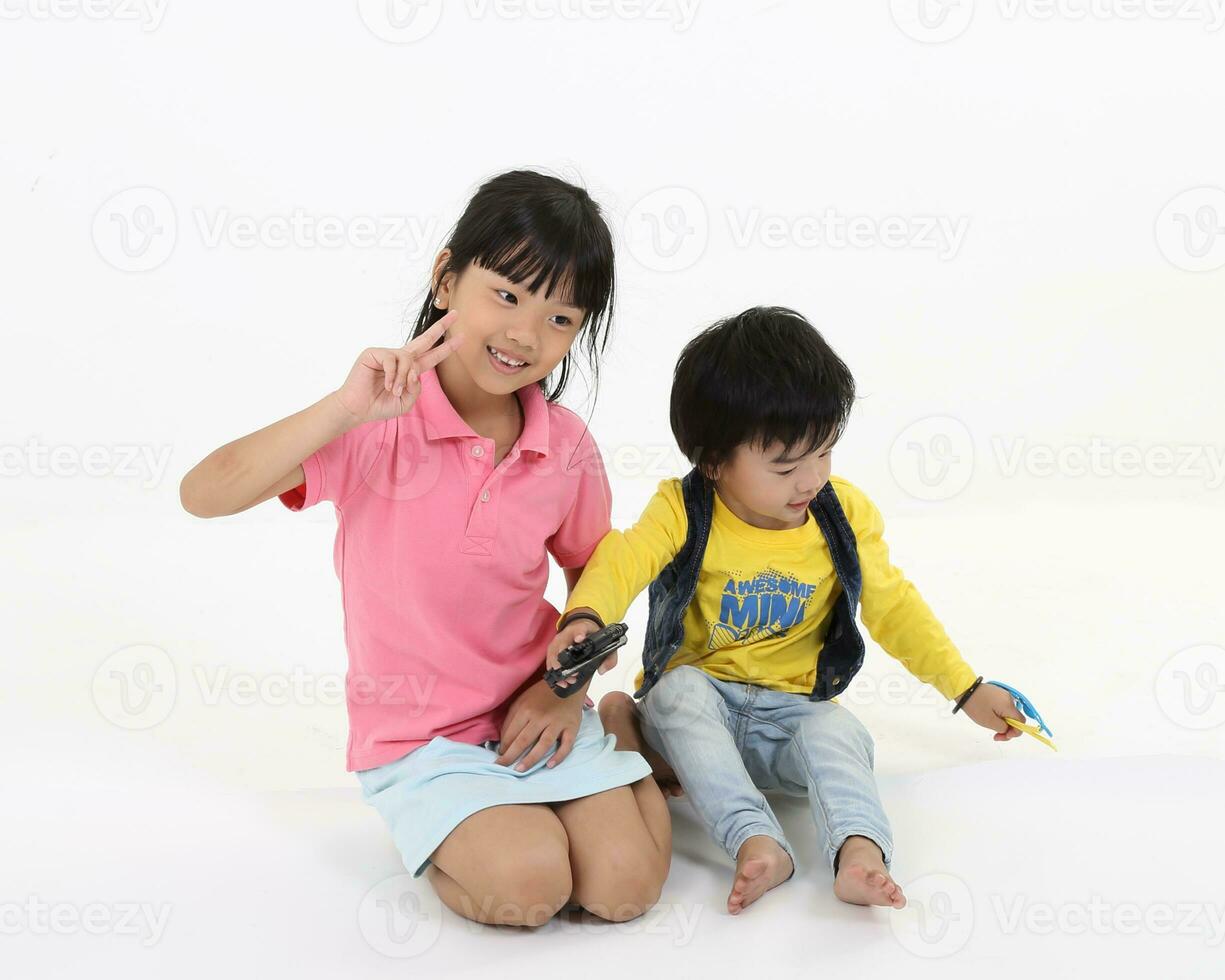 south East Asian brother sister child playing posing on white background photo