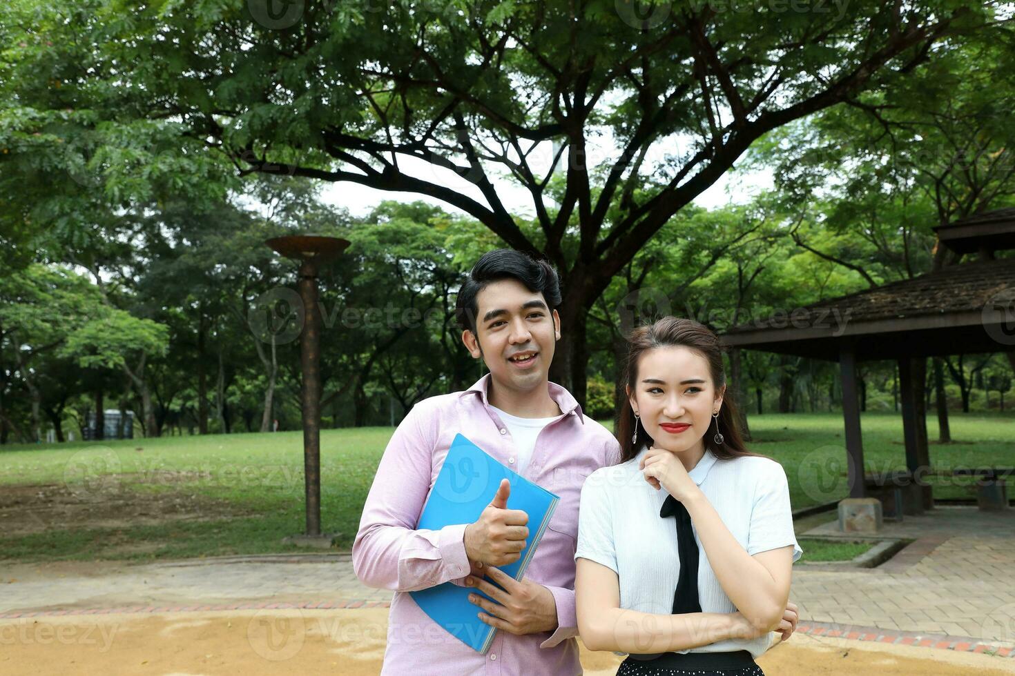 young asian malay chinese man woman outdoor park walk stand study talk discuss laptop file book backpack pose happy mingle photo