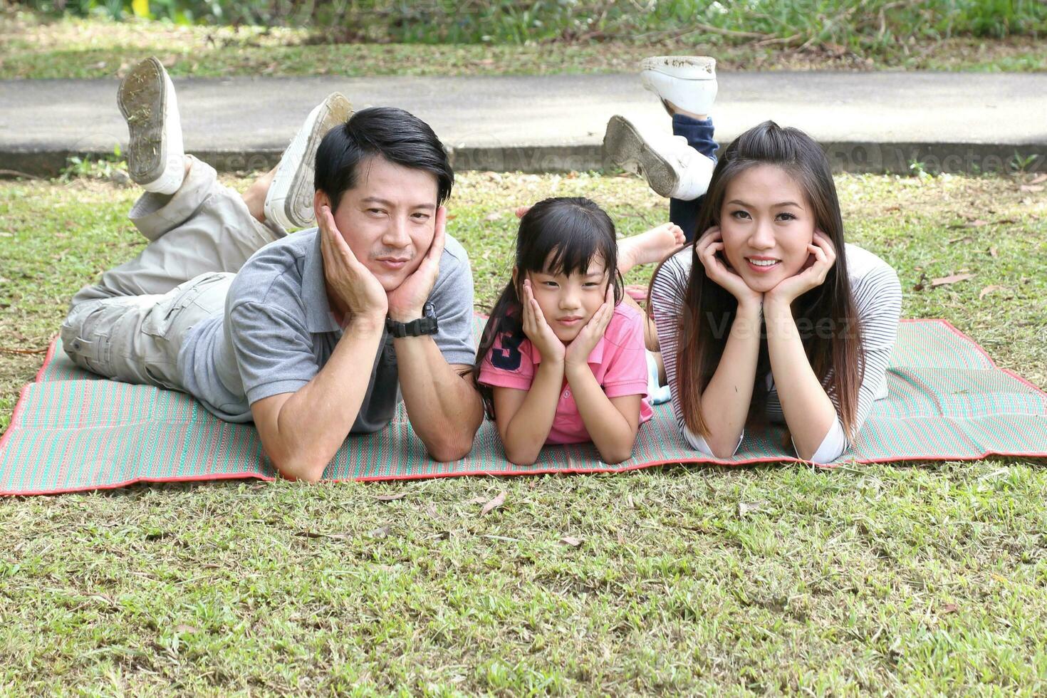 South East Asian young father mother daughter son parent boy girl child activity outdoors park photo