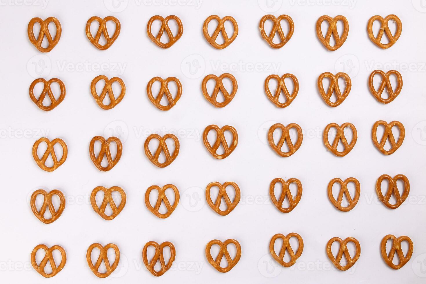 Pretzel cracker laid in rows design on what background photo