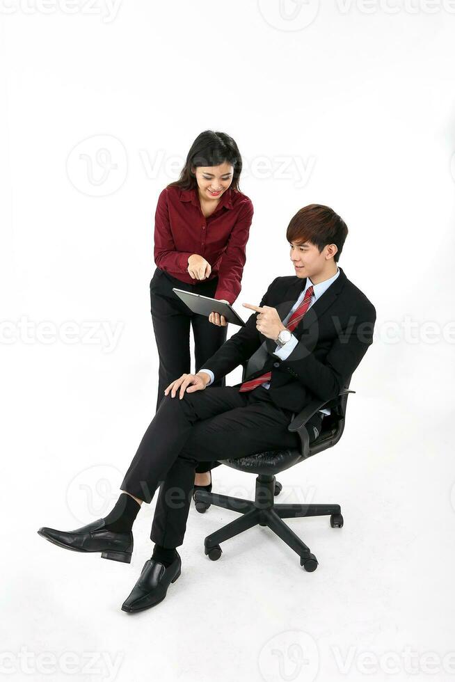 Young attractive man woman business office white background sitting on chair looking discussing pointing tablet pad photo