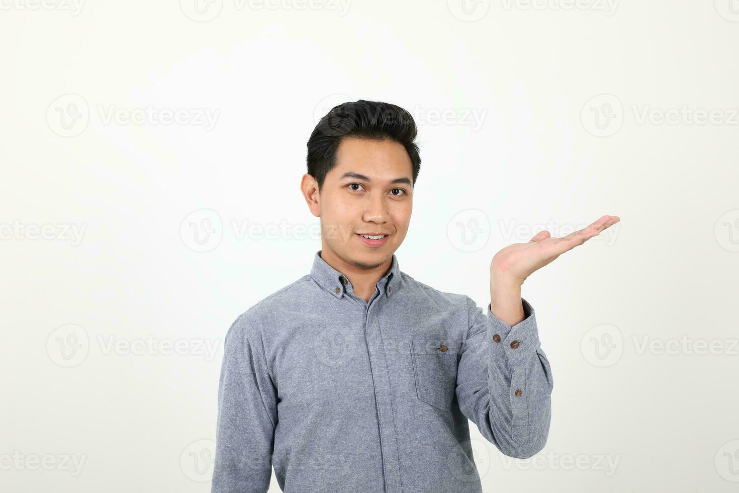 South east Asian Malay Man facial expression show point palm of hand photo