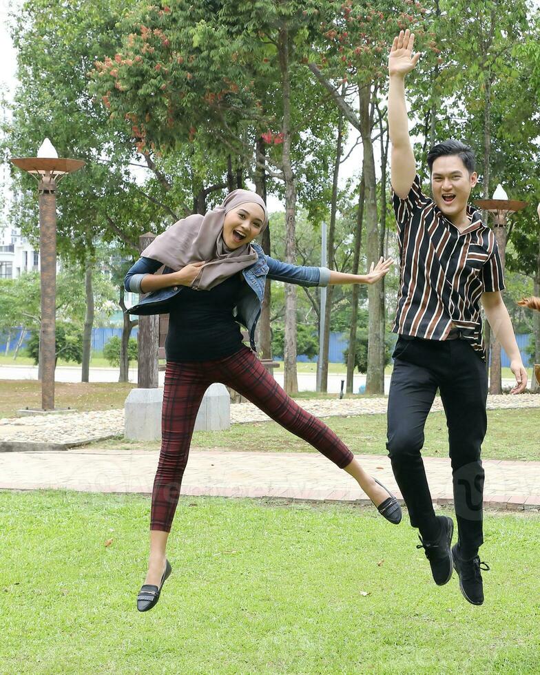 Young Asian different ethnic malay chinse  man woman activity lifestyle student educating job business jump in air photo